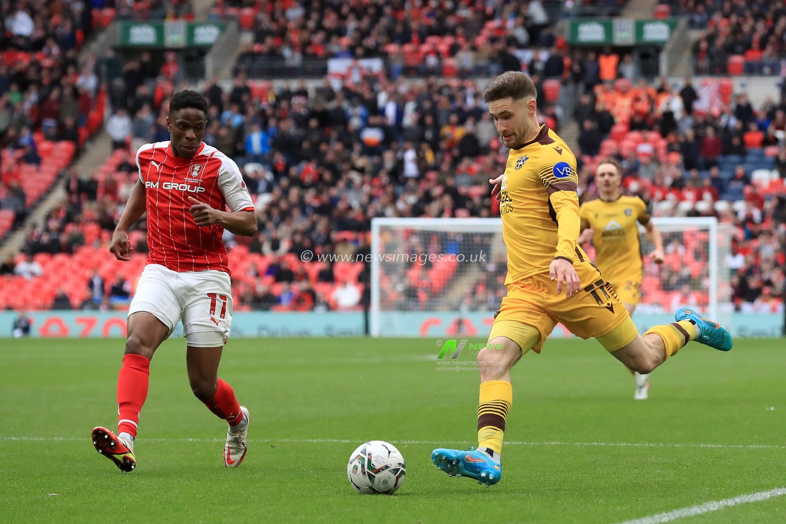 Will Randall #11 of Sutton United and Chiedozie Ogbene #11 of Rotherham United in action.