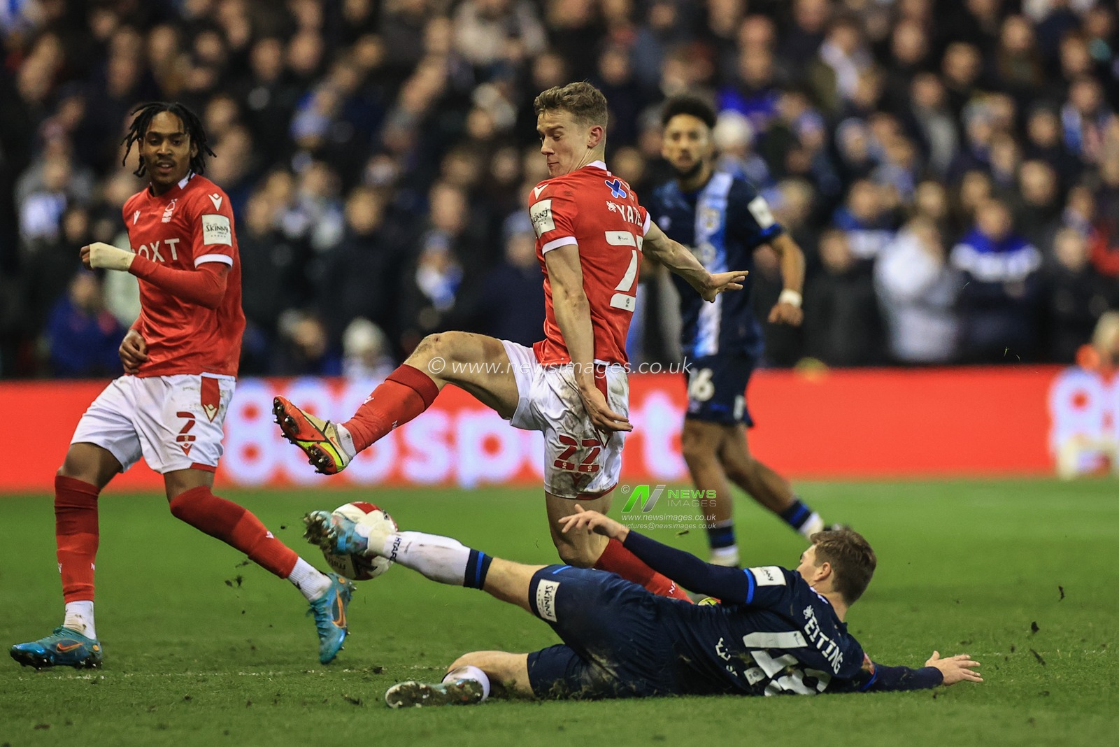 Carel Eiting #48 of Huddersfield Town slides in to win the ball from Ryan Yates #22 of Nottingham Forest