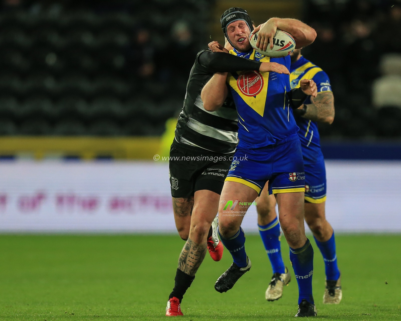 12th March 2020, KCOM Stadium, Hull, England; Betfred Super League, Hull FC v Warrington Wolves : Chris Hill (8) of Warrington Wolves is tackled by Josh Griffin (4) of Hull FC