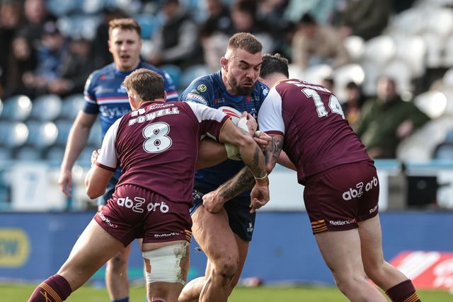 Mike McMeeken of Wakefield Trinity is tackled by Fenton Rogers of Huddersfield Giants and Tristan Powell of Huddersfield Giants during the Betfred Super League Round 2 match Huddersfield Giants vs Wakefield Trinity at Accu Stadium, Huddersfield, United Kingdom on 22 February 2026

(Photo by Mark Cosgrove/News Images)