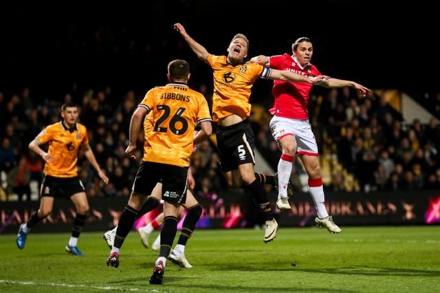 Michael Morrison of Cambridge United jumps for the ball with George Dobson of Wrexham AFC during the Sky Bet League 1 match Cambridge United vs Wrexham at Abbey Stadium, Cambridge, United Kingdom, 1st April 2025

(Photo by Izzy Poles/News Images)