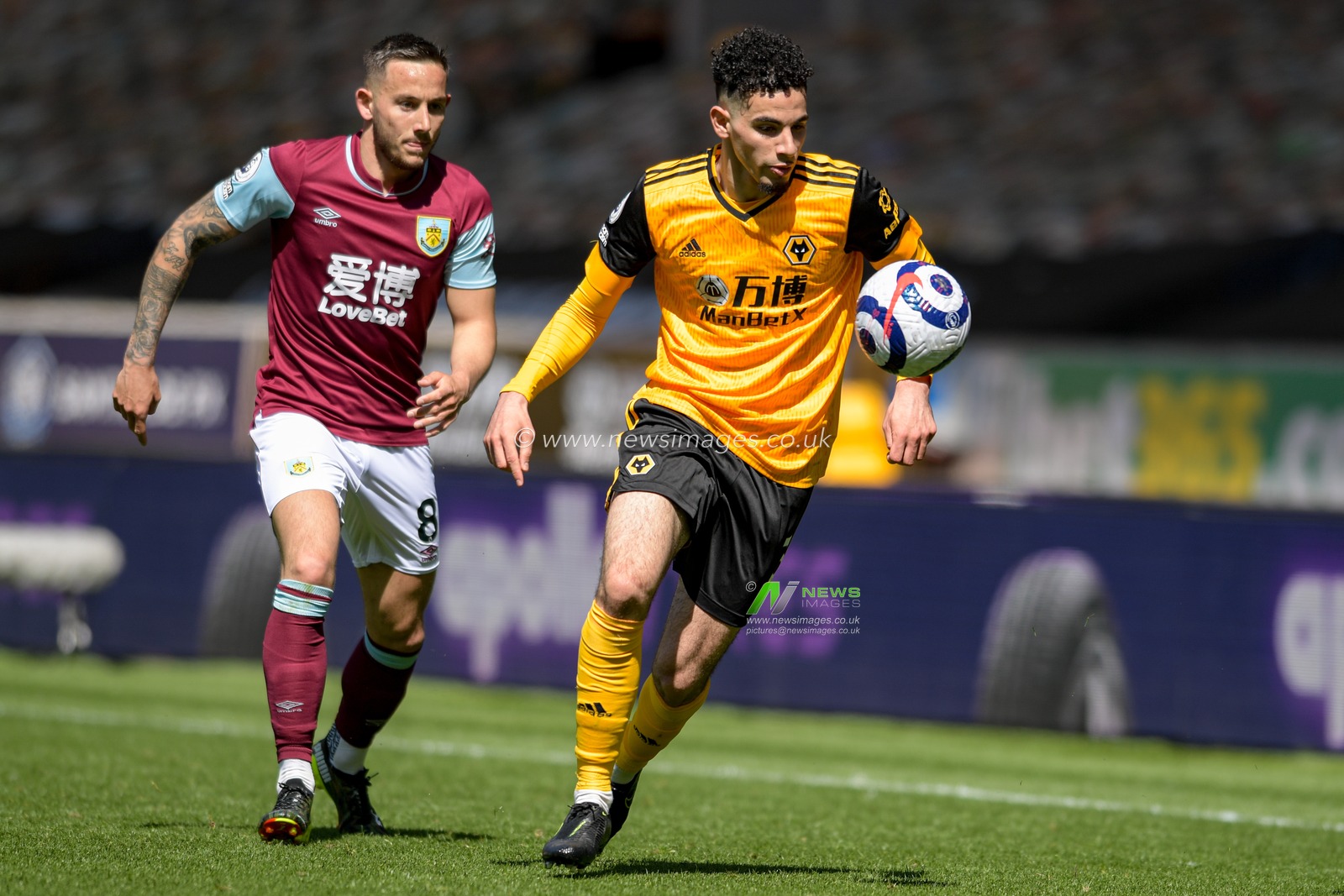 Rayan Ait-Nouri #3 of Wolverhampton Wanderers looks to control the ball while under pressure from Josh Brownhill #8 of Burnley