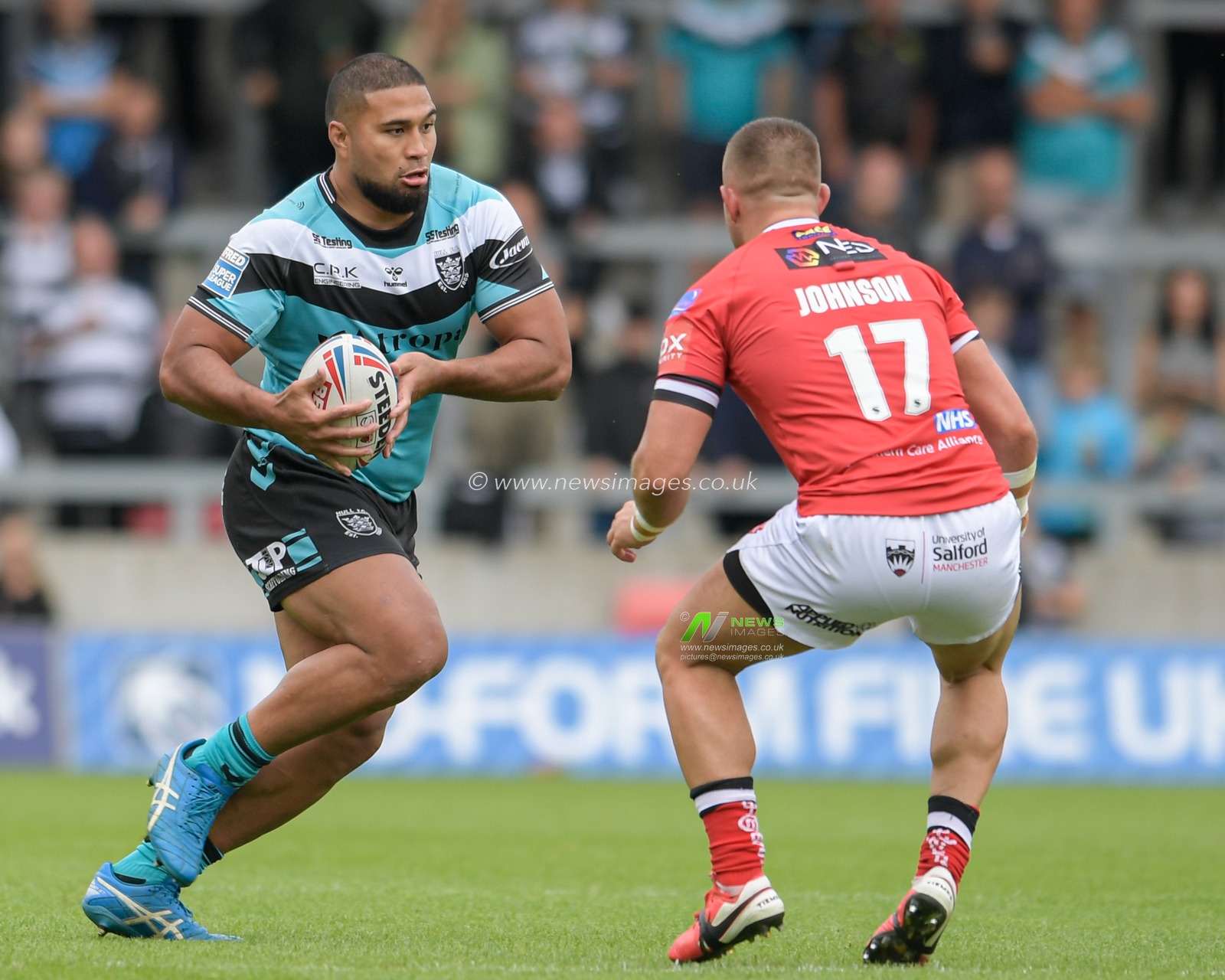 Chris Satae (10) of Hull FC looks for a way past Josh Johnson (17) of Salford Red Devils