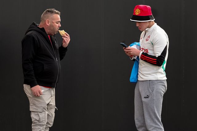 Manchester United fans grab a bite to eat during the Premier League match Manchester United vs Leeds United at Old Trafford, Manchester, United Kingdom on 13 April 2026

(Photo by Mark Cosgrove/News Images)