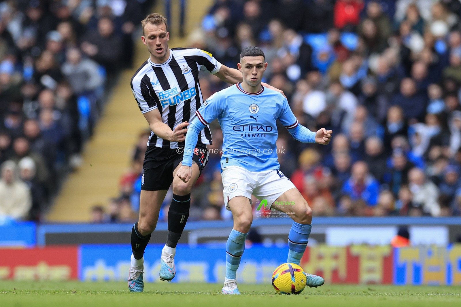 Phil Foden #47 of Manchester City passes the ball under pressure from Dan Burn #33 of Newcastle United during the Premier League match Manchester City vs Newcastle United at Etihad Stadium, Manchester, United Kingdom, 4th March 2023

(Photo by Conor Molloy/News Images)