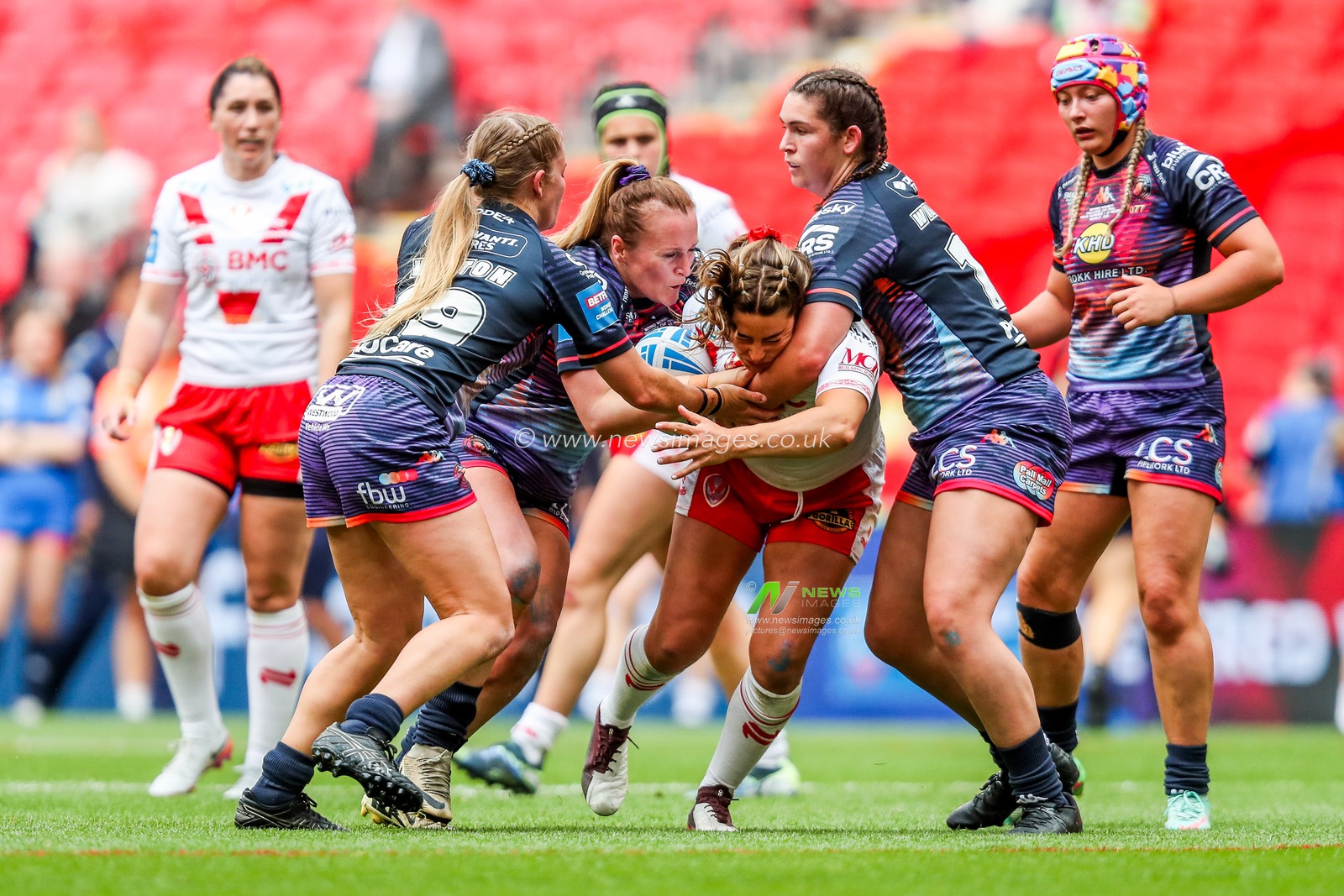 Emily Rudge of St Helens is tackled during the Betfred Women's Challenge Cup Final St Helens vs Wigan Warriors at Wembley Stadium, London, United Kingdom, 7th June 2025

(Photo by Izzy Poles/News Images)