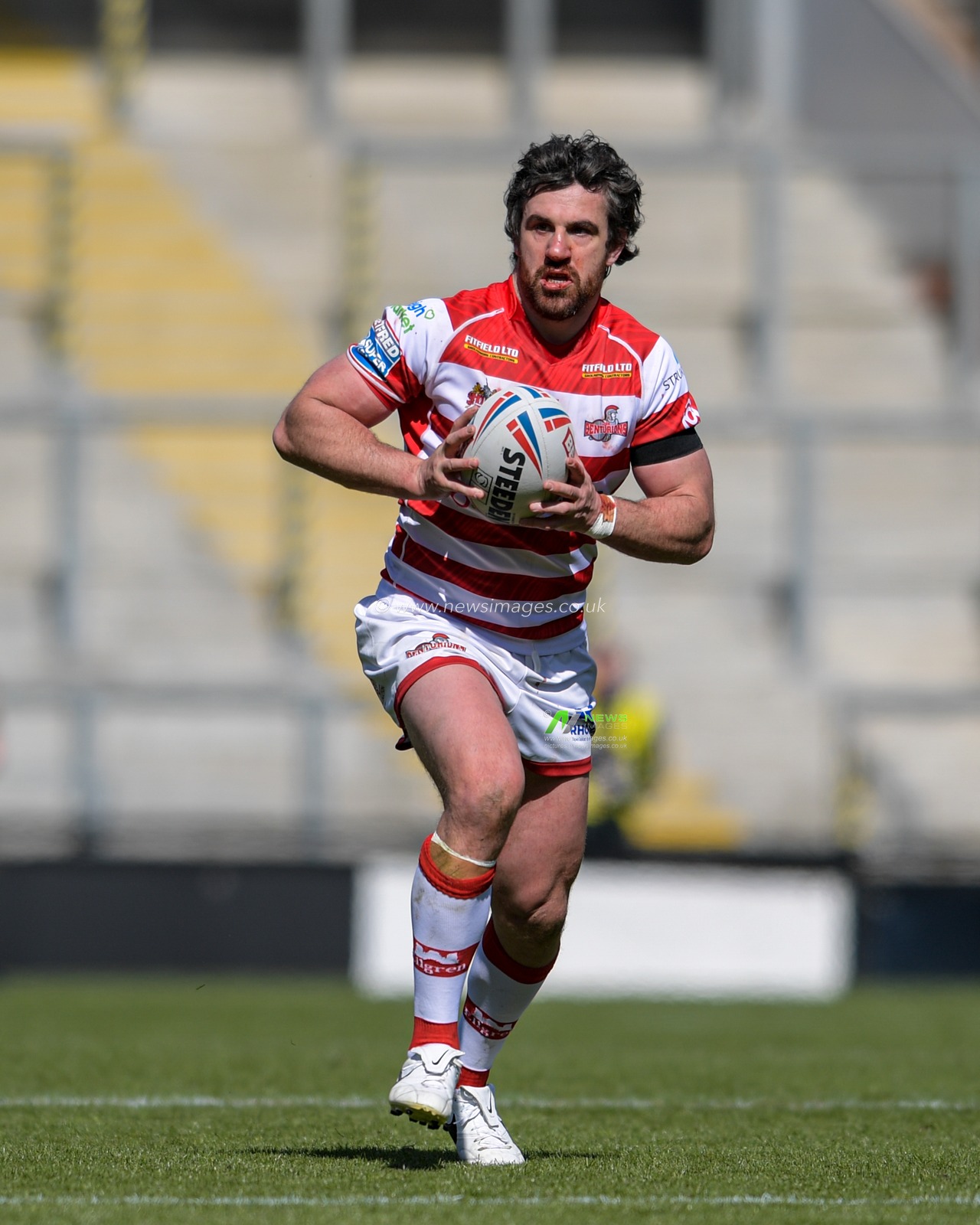 Tyrone McCarthy (21) of Leigh Centurions runs forward with the ball