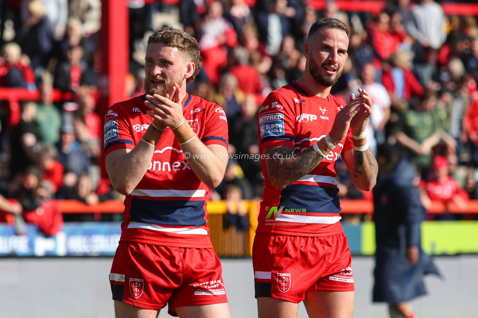 Ethan Ryan #23 of Hull KR and Ben Crooks #2 of Hull KR applaud the home fans