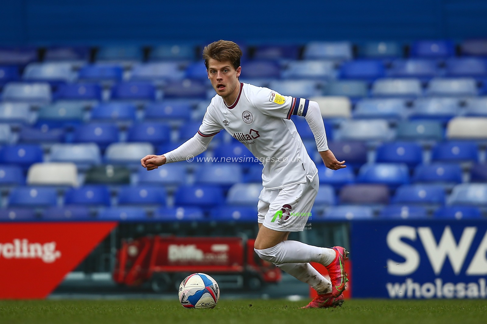 Mathias Jensen #8 of Brentford dribbles the ball
