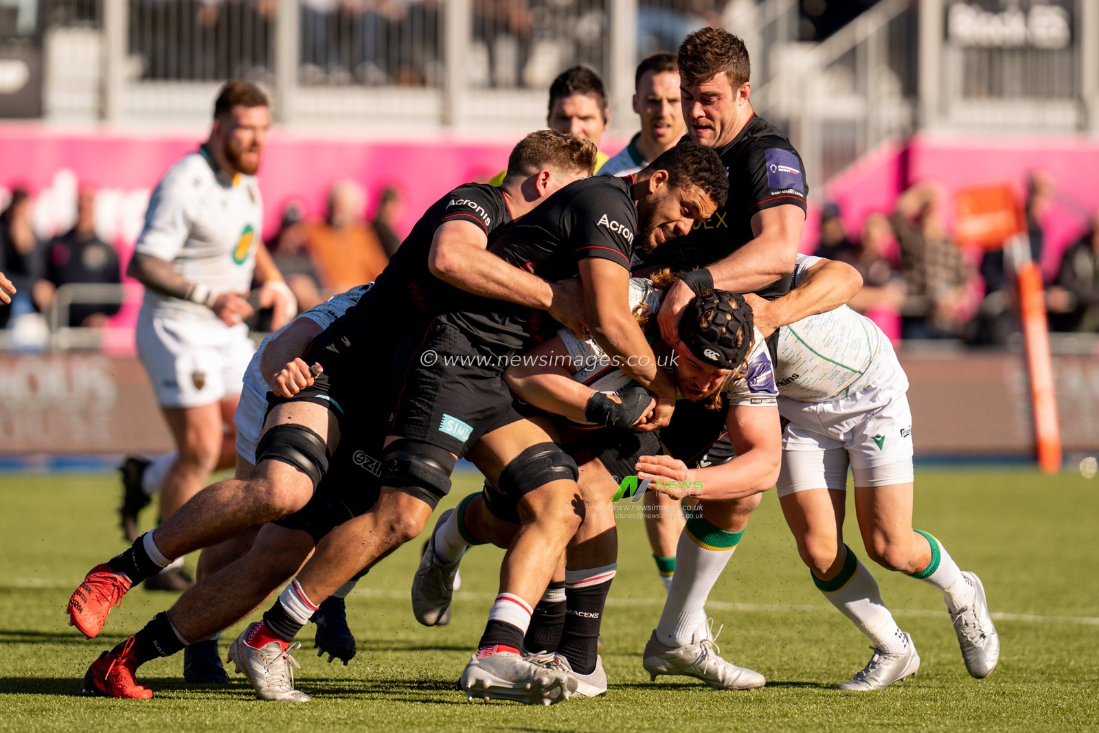 Alex Moon #4 of Northampton Saints powers his way through the Saracens defence
