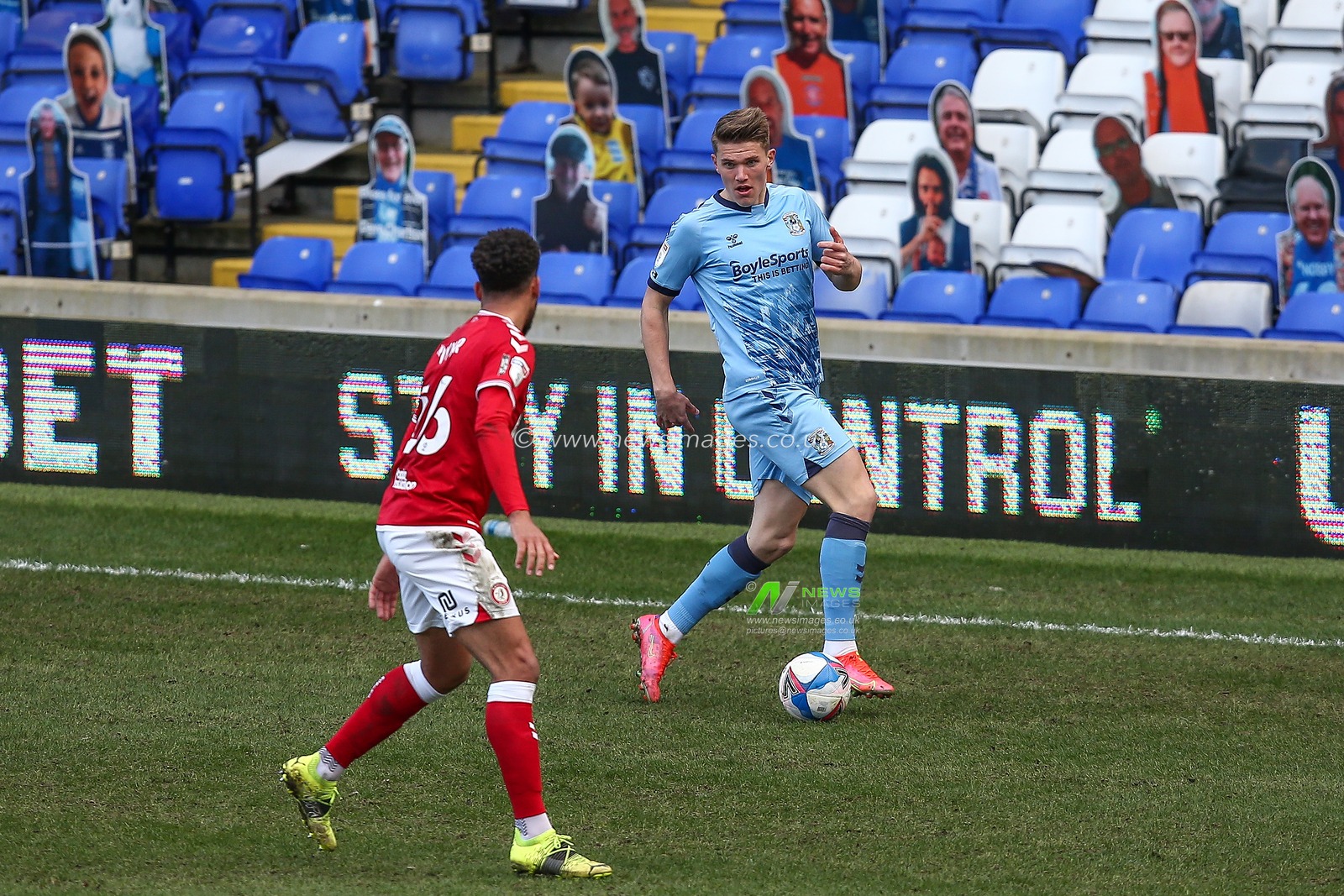 Viktor Gyokeres #12 of Coventry City dribbles the ball whilst under pressure from Zak Vyner #26 of Bristol City