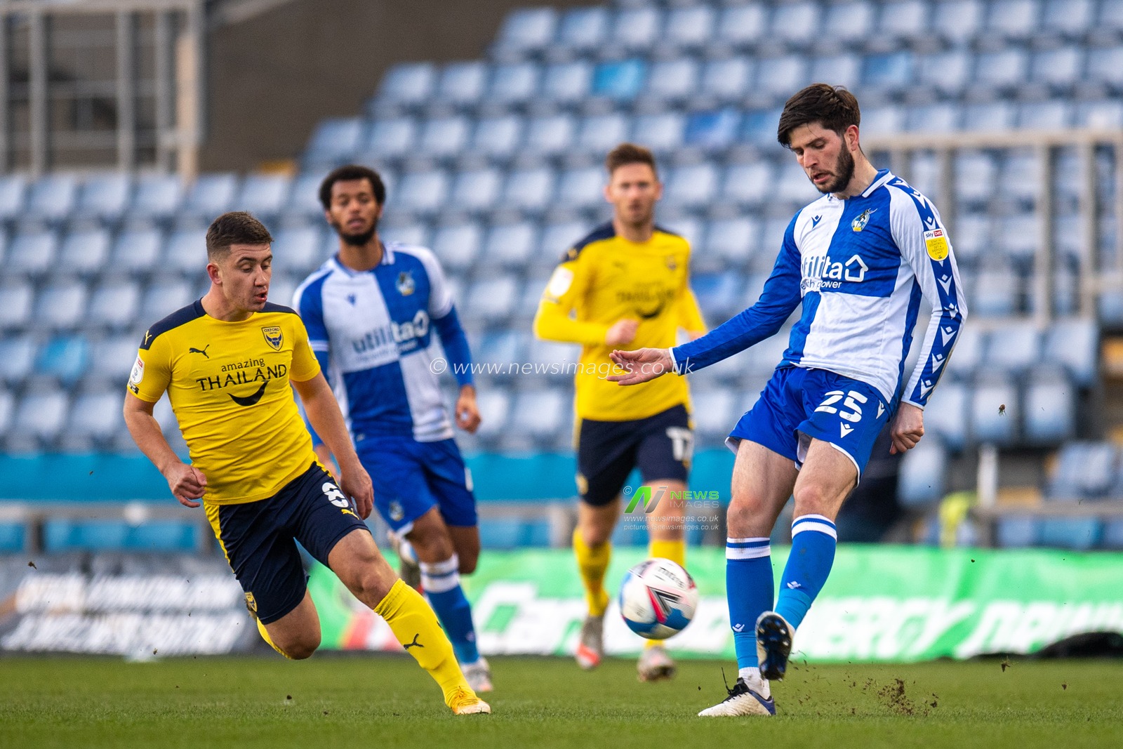 Cian Harries #25 of Bristol Rovers passes the ball under pressure from Cameron Brannagan #8 of Oxford United