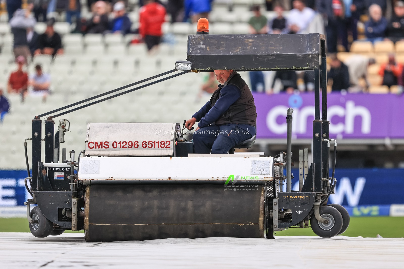 Ground staff at Edgbaston clear water off the covers in an attempt to get the game underway