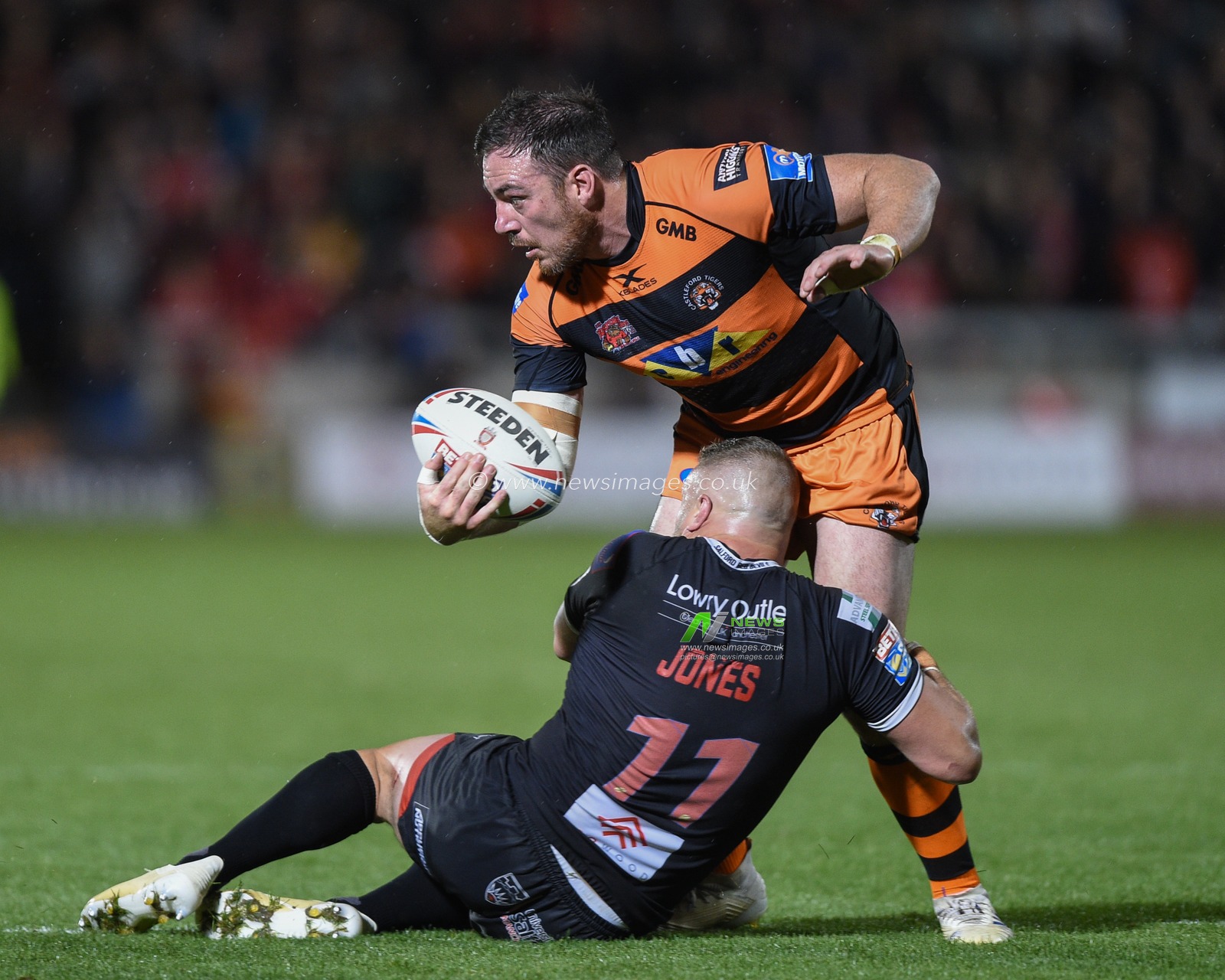 26th September 2019 ,  AJ Bell Stadium, Salford, England;  Betfred Super League Rugby, Round Eliminator 2, Salford Red Devils vs Castleford Tigers ; Grant Millington (10) of Castleford Tigers is tackled by Josh Jones (11) of Salford Red Devils 

Credit: Richard Long/News Images