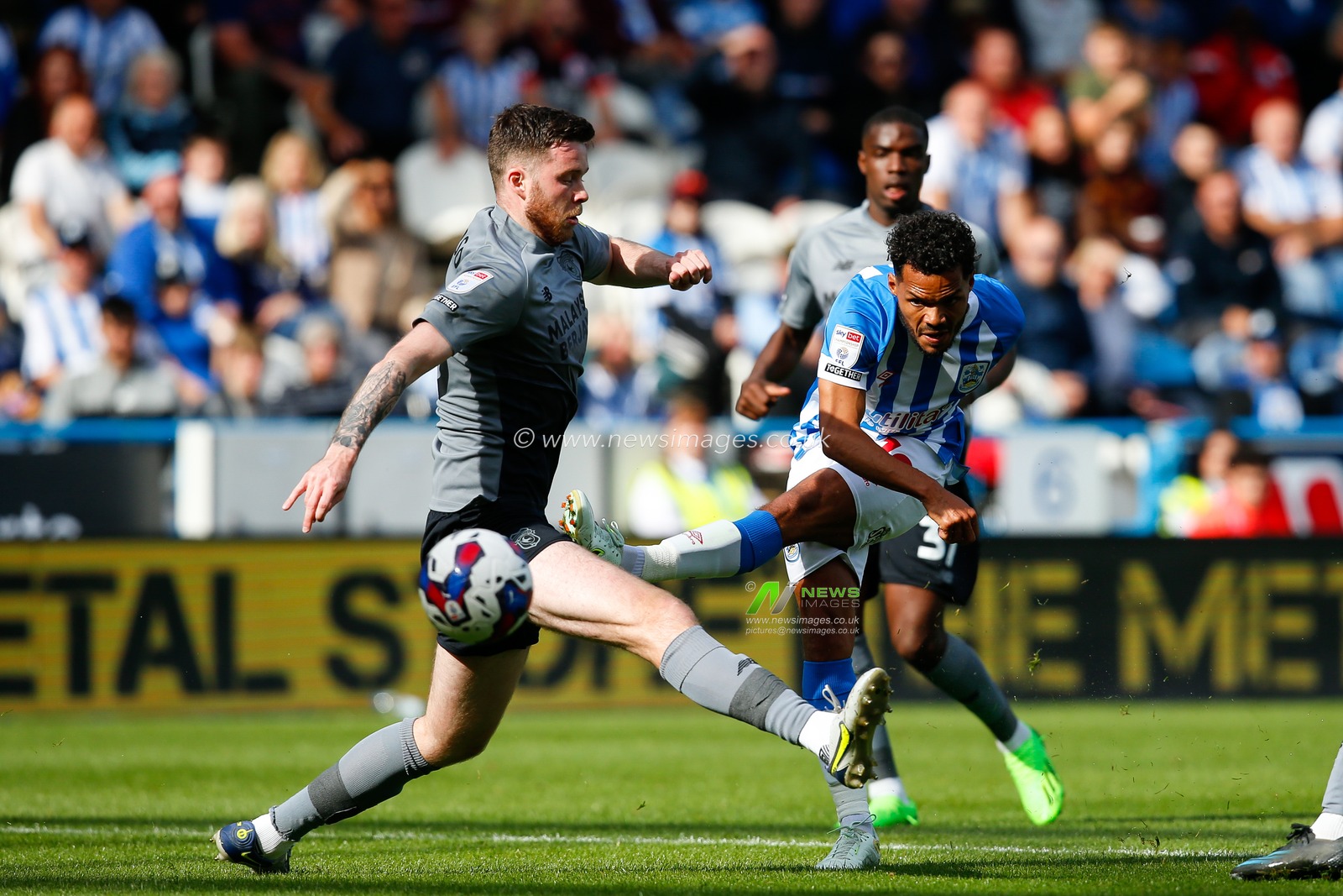 Duane Holmes #19 of Huddersfield Town attempts a shot on goal during the Sky Bet Championship match Huddersfield Town vs Cardiff City at John Smith's Stadium, Huddersfield, United Kingdom, 17th September 2022

(Photo by Ben Early/News Images)