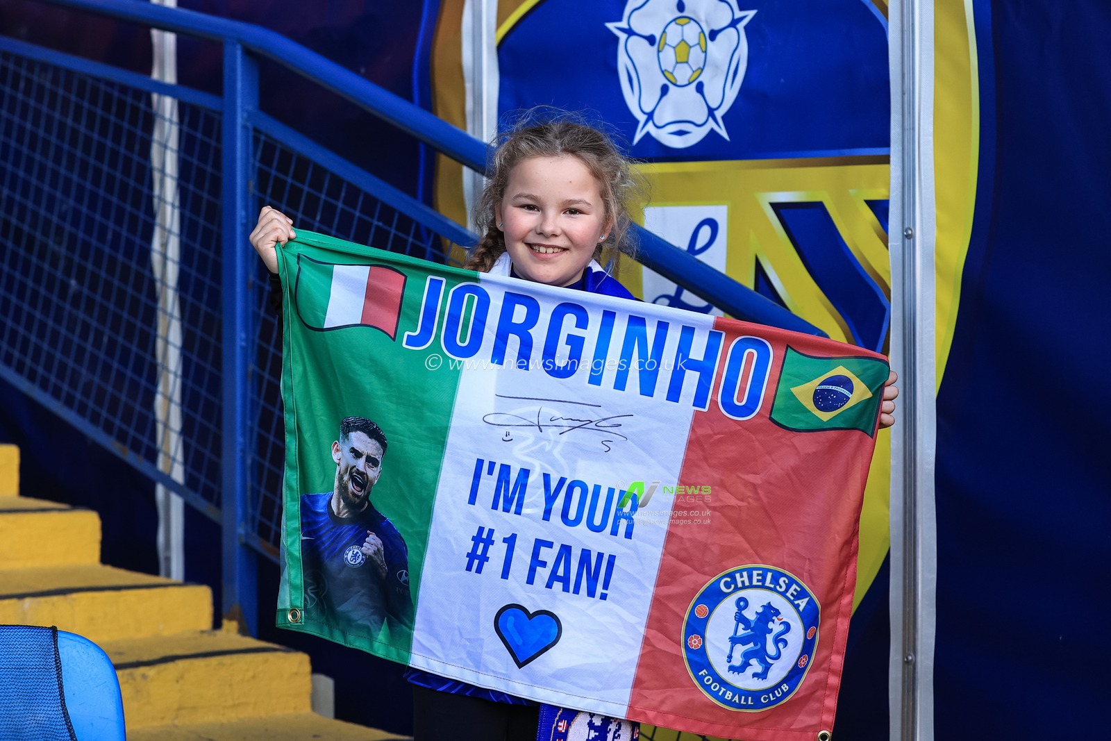 A young Chelsea fan with a Jorginho #5 of Chelsea flag