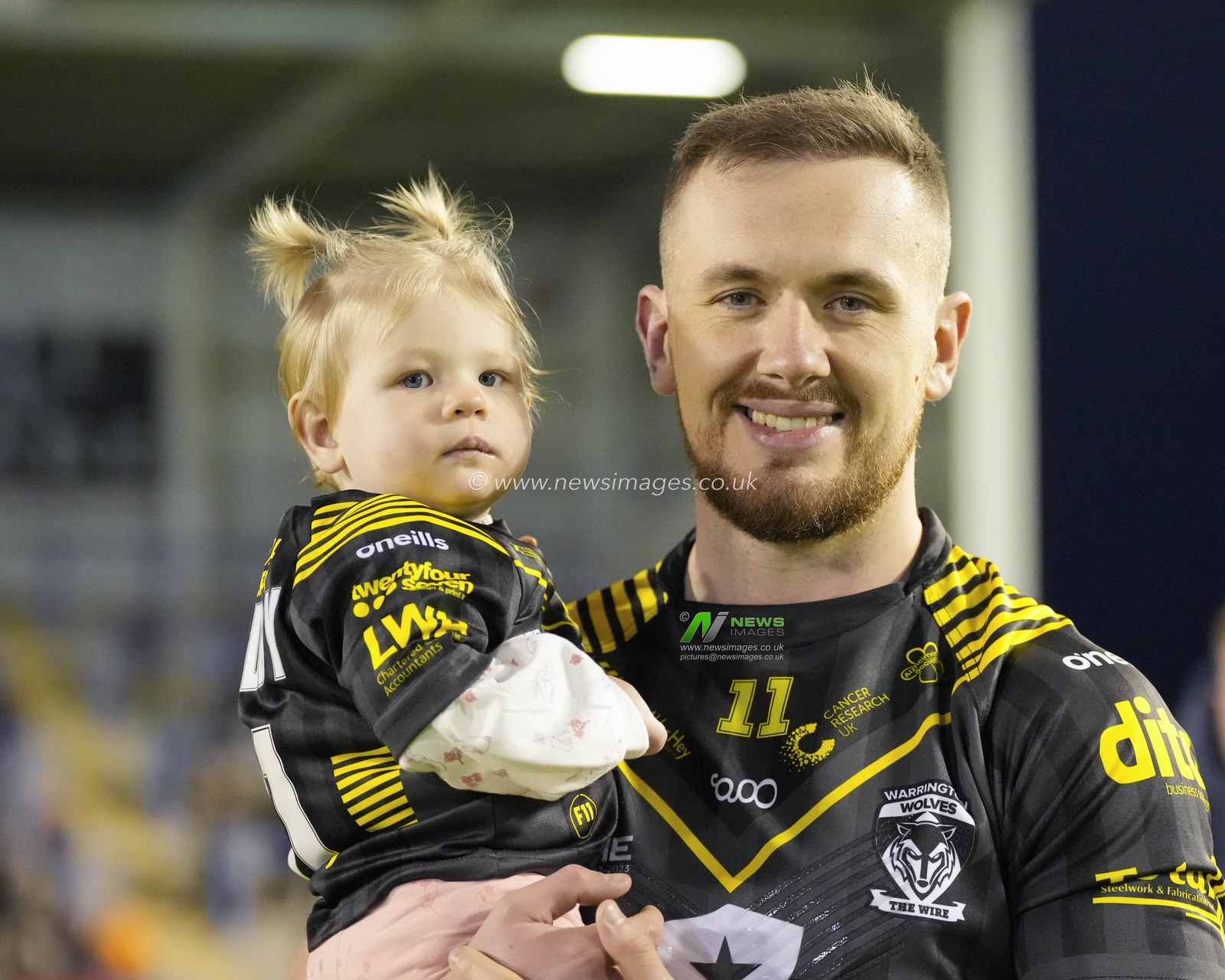 Ben Currie #11 of Warrington Wolves poses for a photo with his daughter before the Rugby League Ben Currie Testimonial match Warrington Wolves vs Leigh Leopards at Halliwell Jones Stadium, Warrington, United Kingdom, 4th February 2023

(Photo by Steve Flynn/News Images)