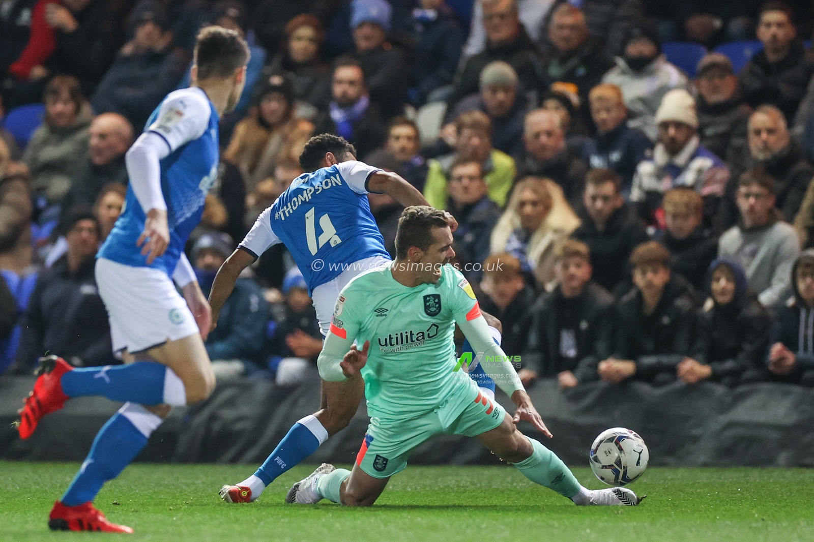 Harry Toffolo #3 of Huddersfield Town is fouled by Nathan Thompson #4 of Peterborough United