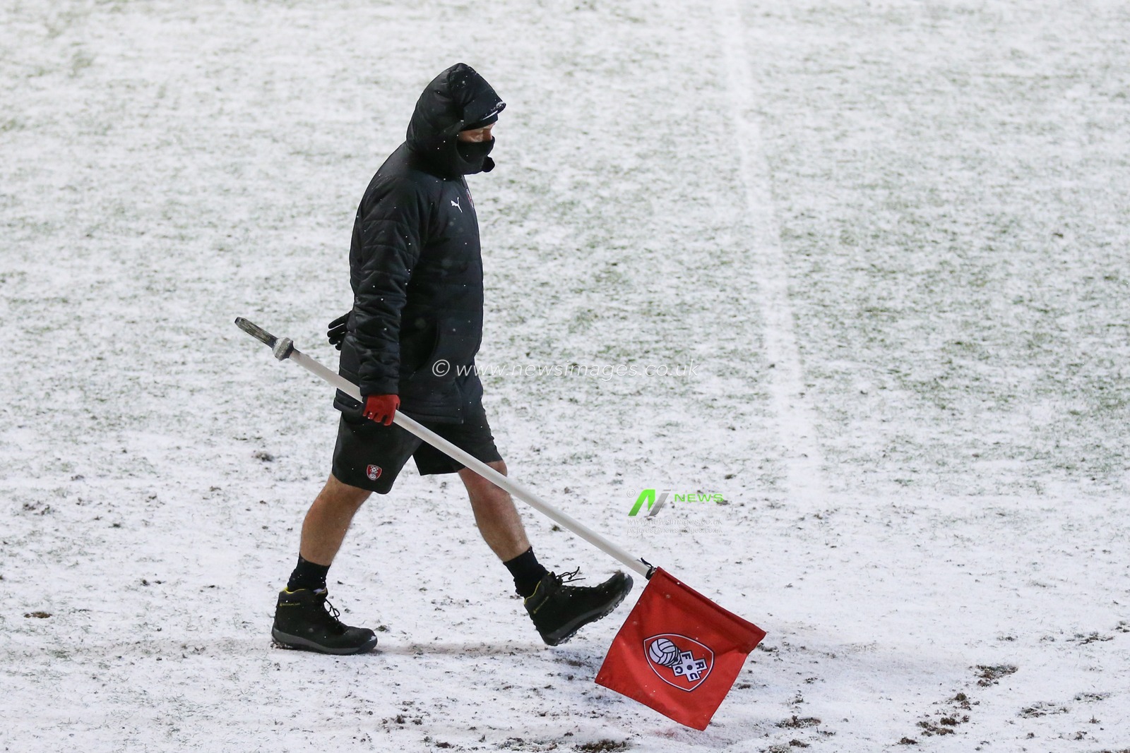 a member of the ground staff collects the corner flag after the game