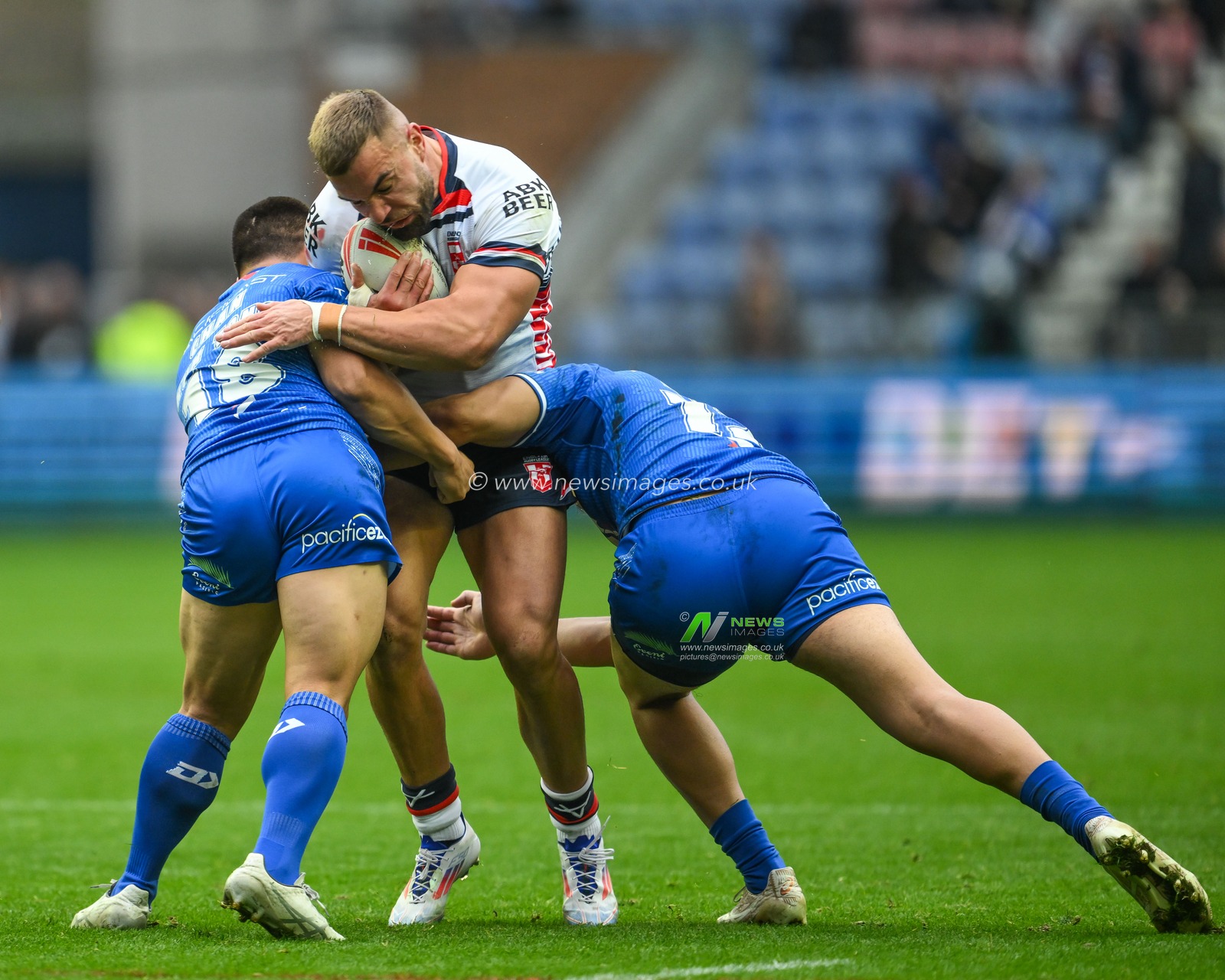 Mike McMeeken of England is tackled by Gordon Chan Kum Tong and Jeremiah Nanai of Samoa  during the ABK Beer Internationals Series match England vs Samoa at The Brick Community Stadium, Wigan, United Kingdom, 27th October 2024

(Photo by Craig Thomas/News Images)