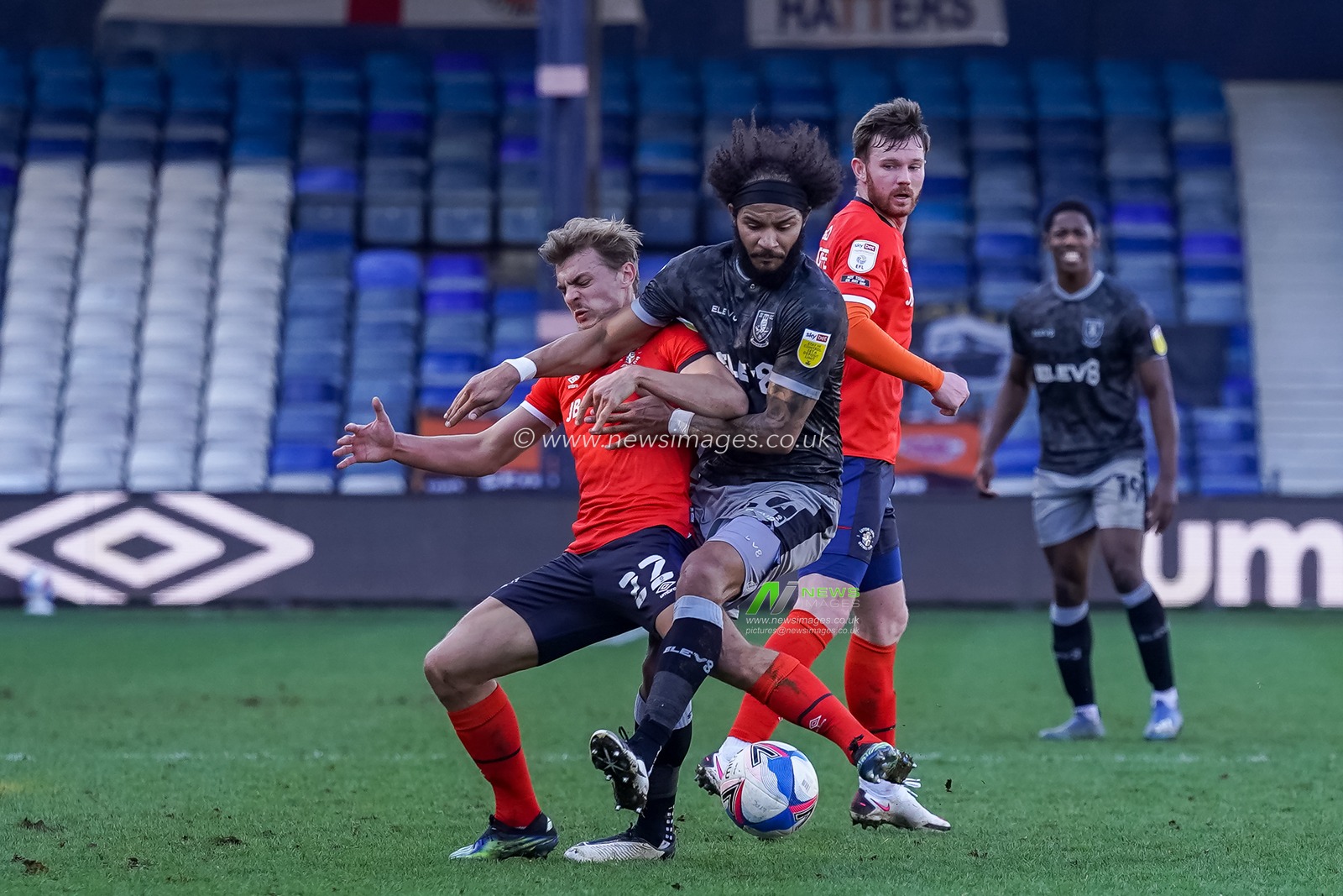 Kiernan Dewsbury-Hall #22 of Luton Town battles Isaiah Brown #24 of Sheffield Wednesday