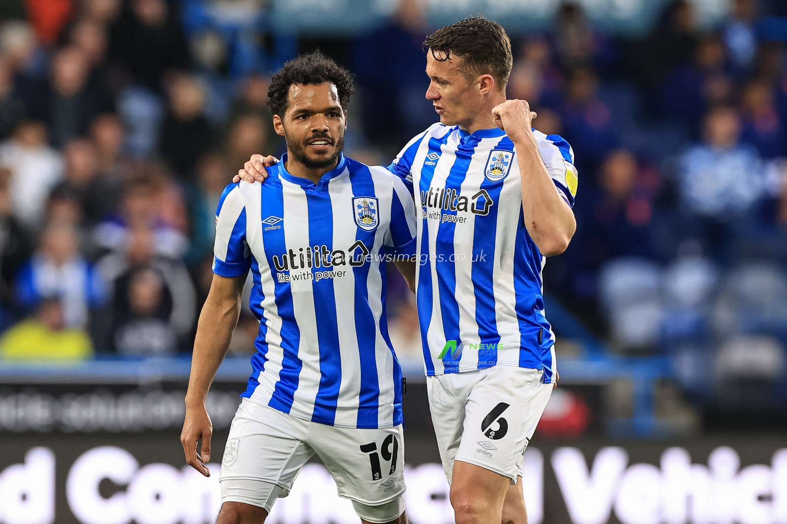 Jonathan Hogg #6 of Huddersfield Town talks to Duane Holmes #19 of Huddersfield Town