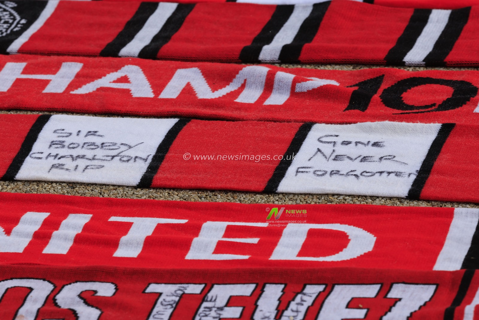 Scarves laid out in tribute to the late Sir Bobby Charlton outside of Old Trafford, Manchester, United Kingdom, 23rd October 2023

(Photo by Conor Molloy/News Images)