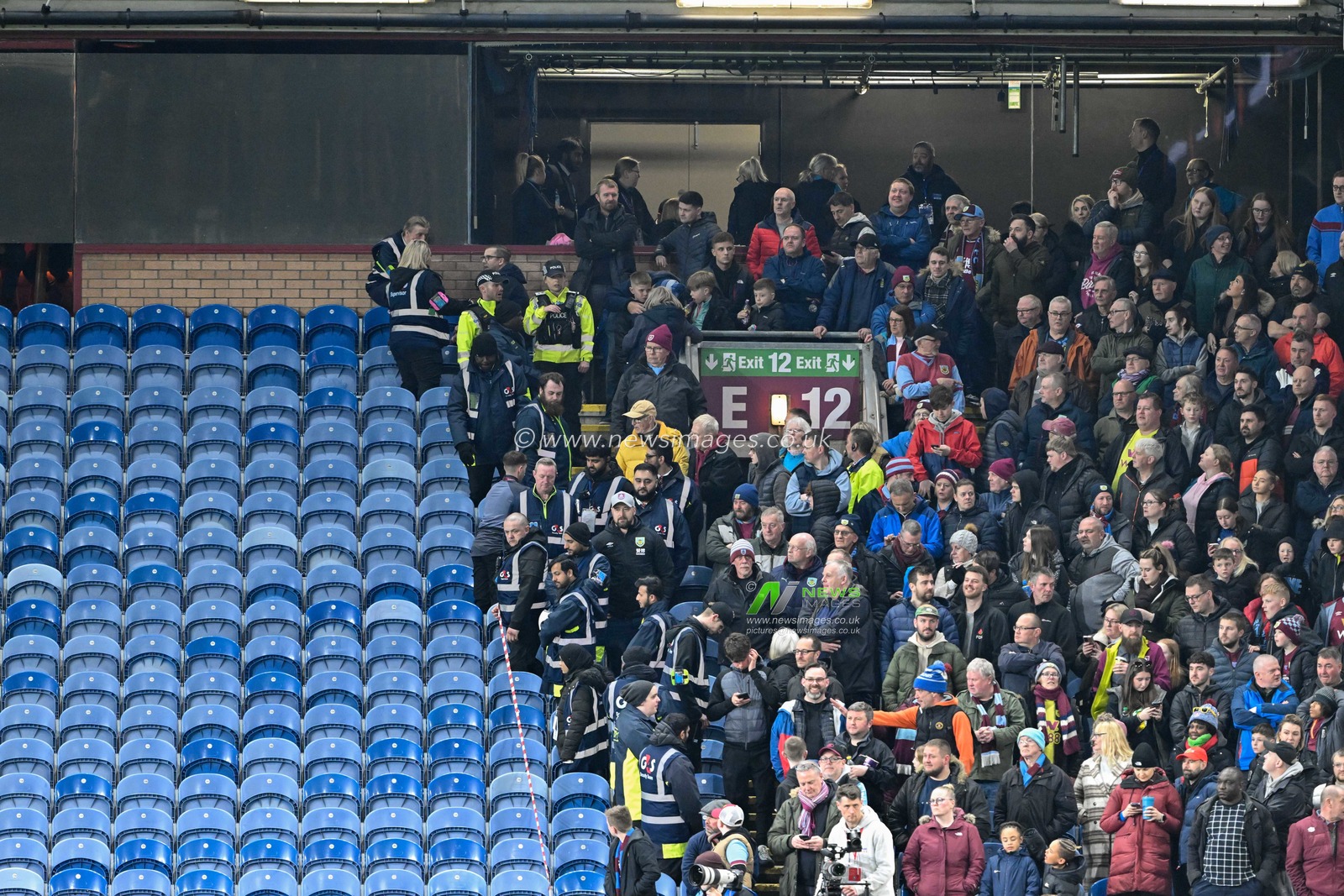 Stewards clear fans from their seats, during the Premier League match Burnley vs Wolverhampton Wanderers at Turf Moor, Burnley, United Kingdom, 2nd April 2024

(Photo by Cody Froggatt/News Images)