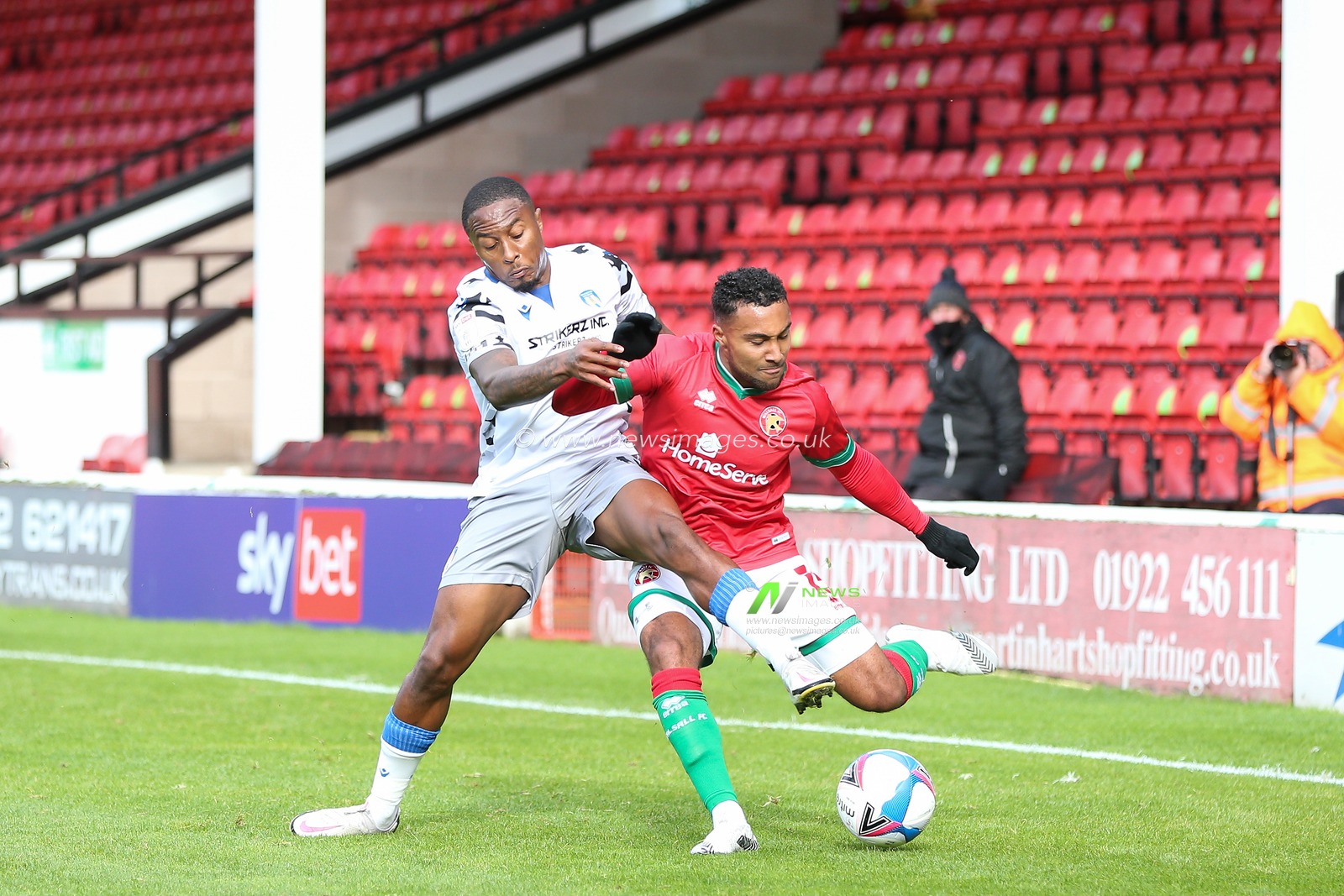 Wes McDonald (15) of Walsall  is tackled by Callum Harriot (11) of Colchester United