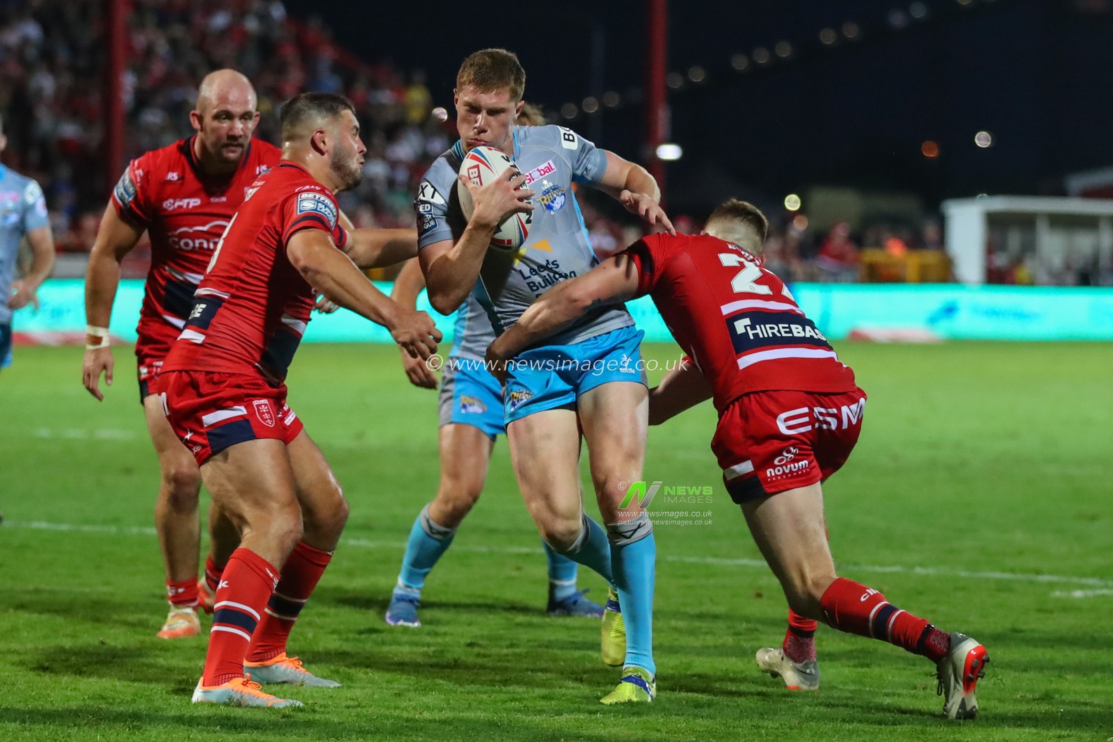 Morgan Gannon #21 of Leeds Rhinos is tackled by Frankie Halton #27 of Hull KR