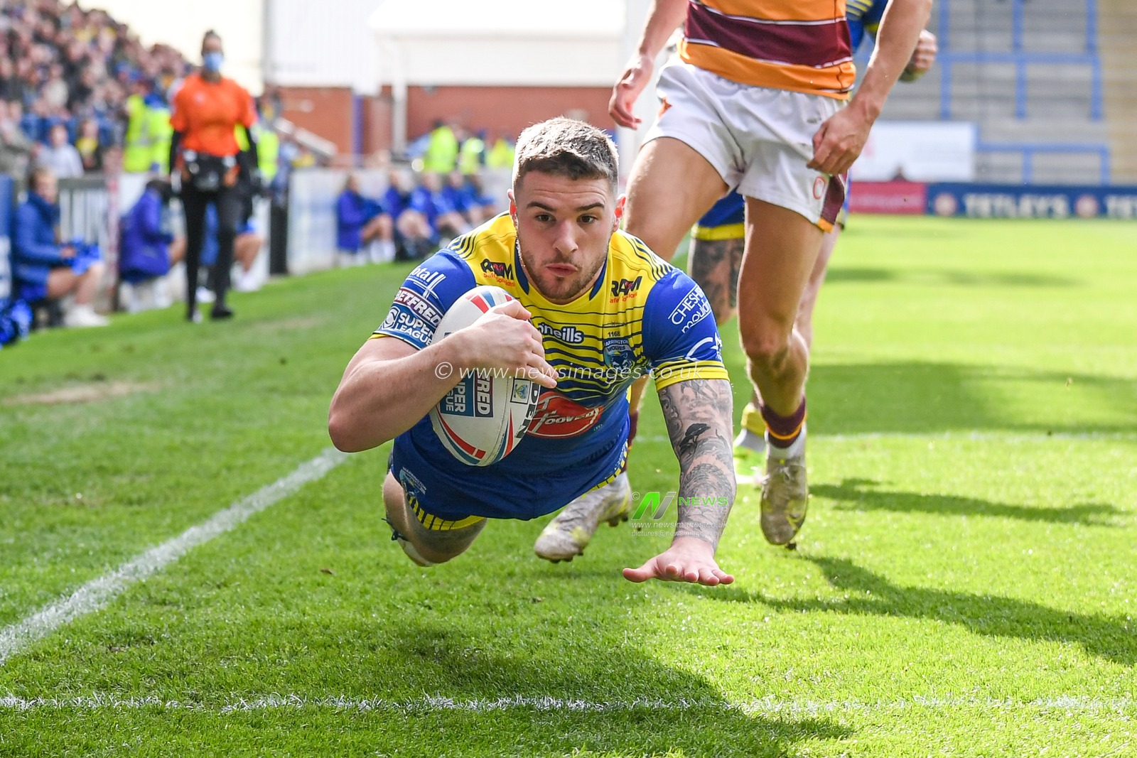 Connor Wrench #23 of Warrington Wolves goes over for a try to make it 22-4