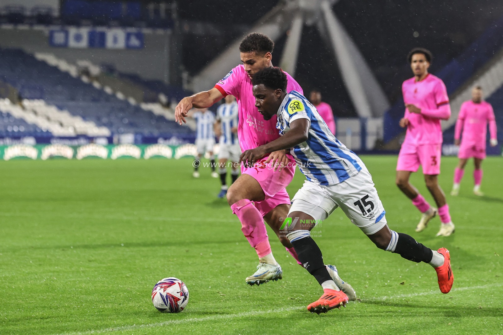 Jaheim Headley of Huddersfield Town and Kyran Lofthouse of Barnsley battle for the ball during the Bristol Street Motors Trophy match Huddersfield Town vs Barnsley at John Smith's Stadium, Huddersfield, United Kingdom, 8th October 2024

(Photo by Alfie Cosgrove/News Images)