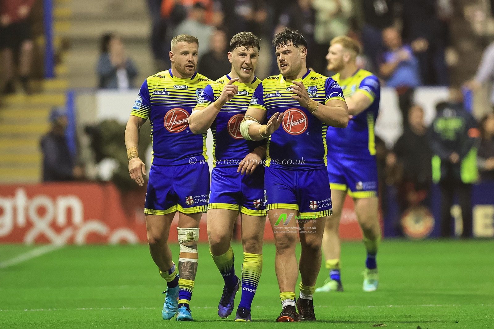 Oliver Holmes #12 of Warrington Wolves, George Williams #7 of Warrington Wolves and Joe Philbin #8 of Warrington Wolves after the final hooter