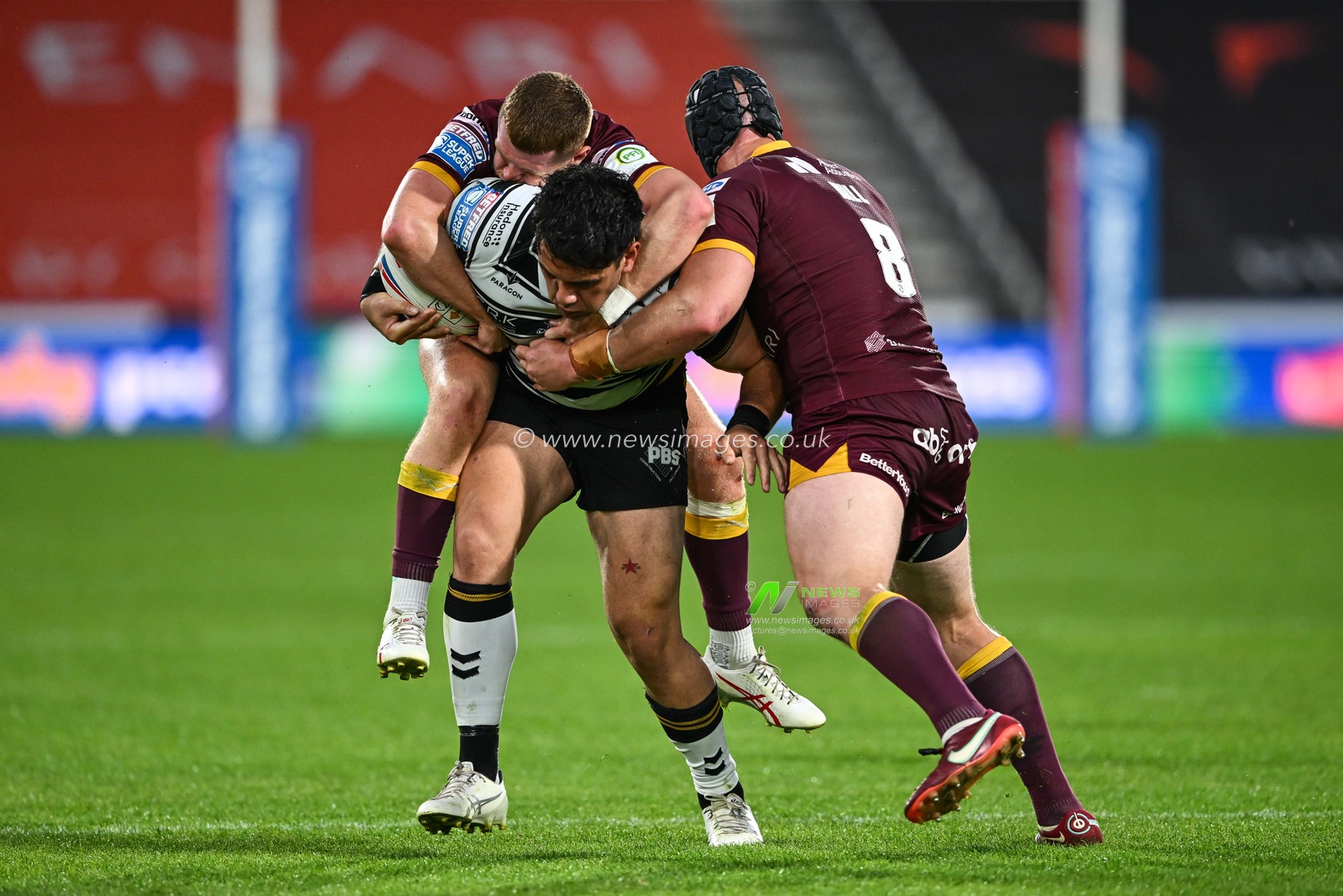 Olly Russell #23 and Chris Hill #8 of Huddersfield Giants   tackle Andre Savelio #11 of Hull FC during the Betfred Super League Round 20 match Huddersfield Giants vs Hull FC at John Smith's Stadium, Huddersfield, United Kingdom, 27th July 2023

(Photo by Craig Thomas/News Images)