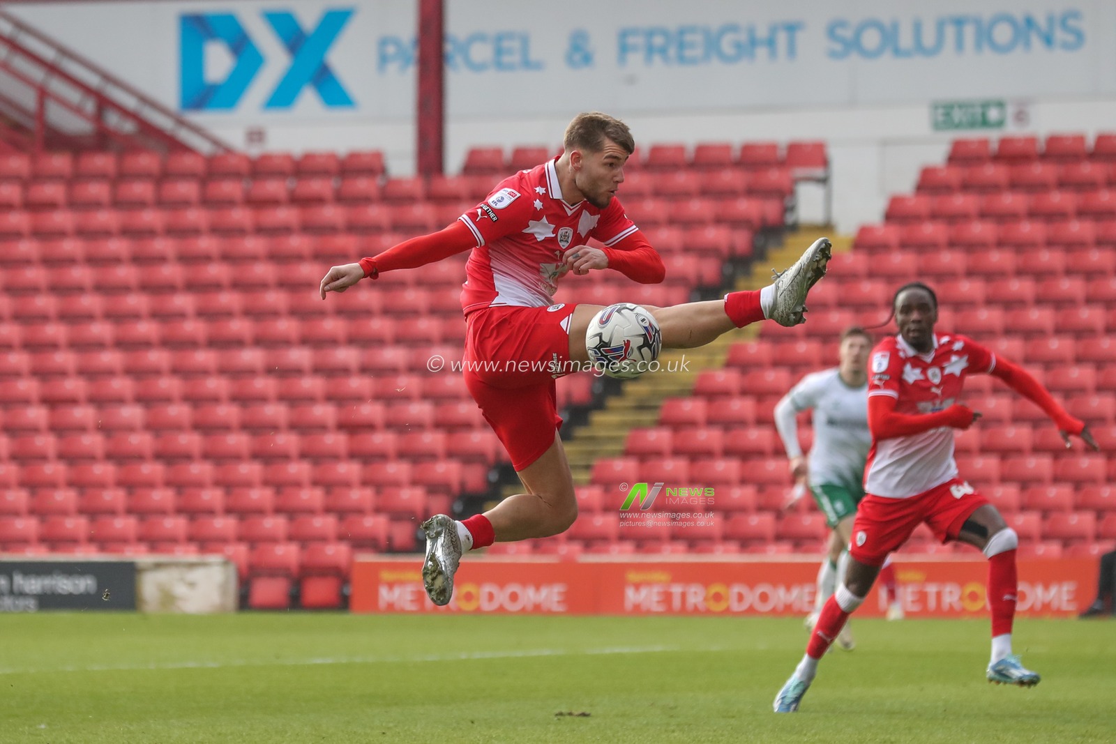 John Mcatee of Barnsley misses the ball as it comes across the box during the Sky Bet League 1 match Barnsley vs Lincoln City at Oakwell, Barnsley, United Kingdom, 9th March 2024

(Photo by Alfie Cosgrove/News Images)