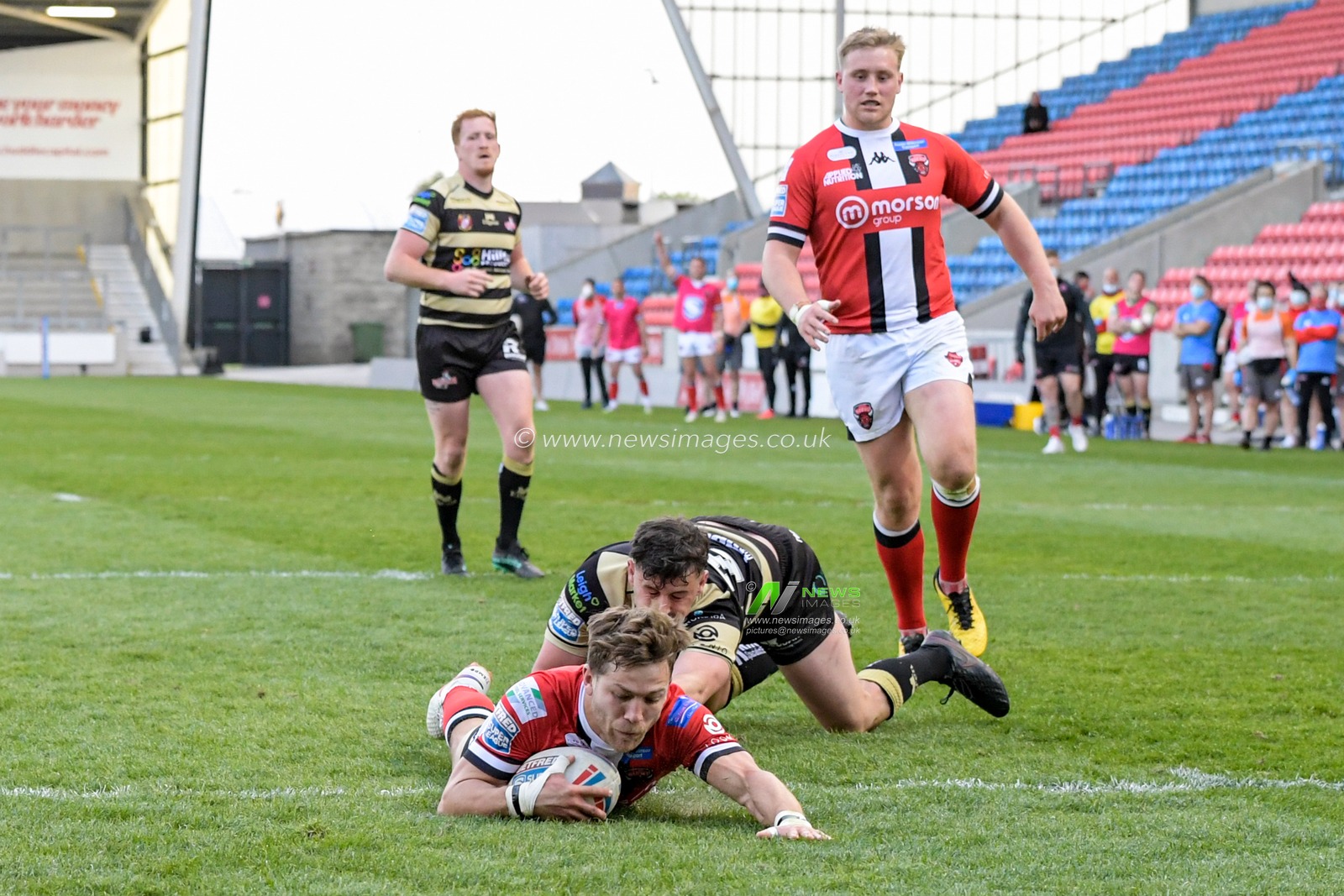 Chris Atkin (18) of Salford Red Devils goes over for a try to make it 26-8