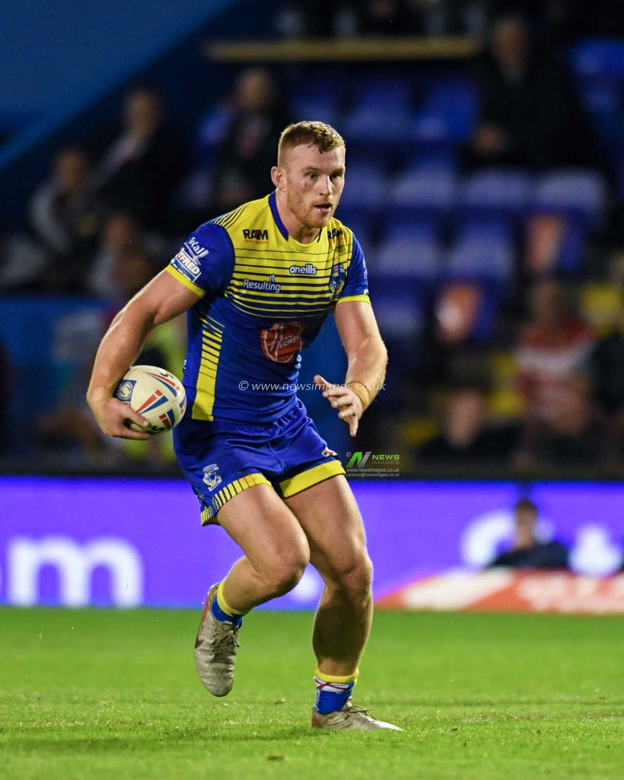 Jack Hughes #13 of Warrington Wolves in action during the game