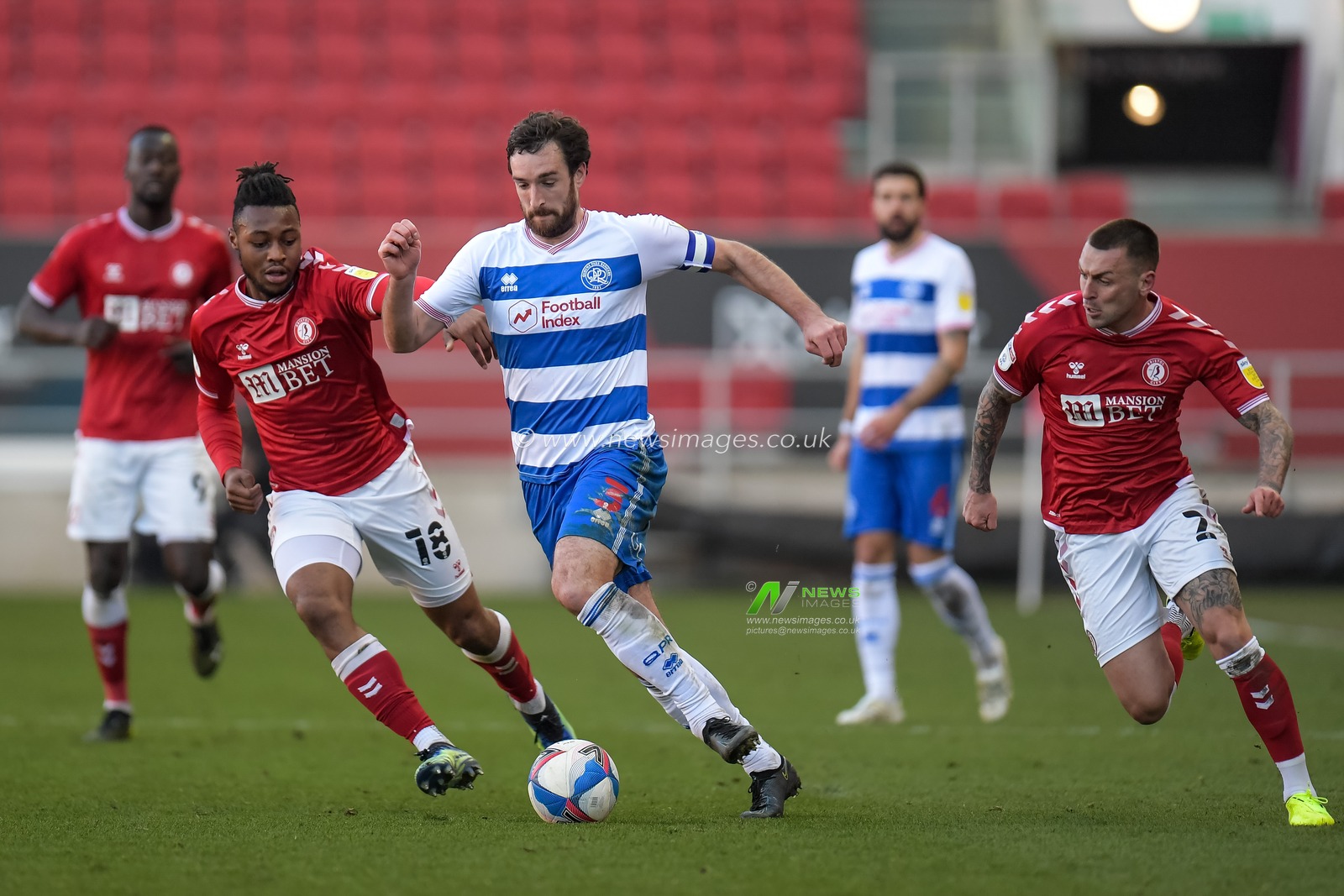 Lee Wallace #3 of Queens Park Rangers cuts past Antoine Semenyo #18 of Bristol City and Jack Hunt #2 of Bristol City