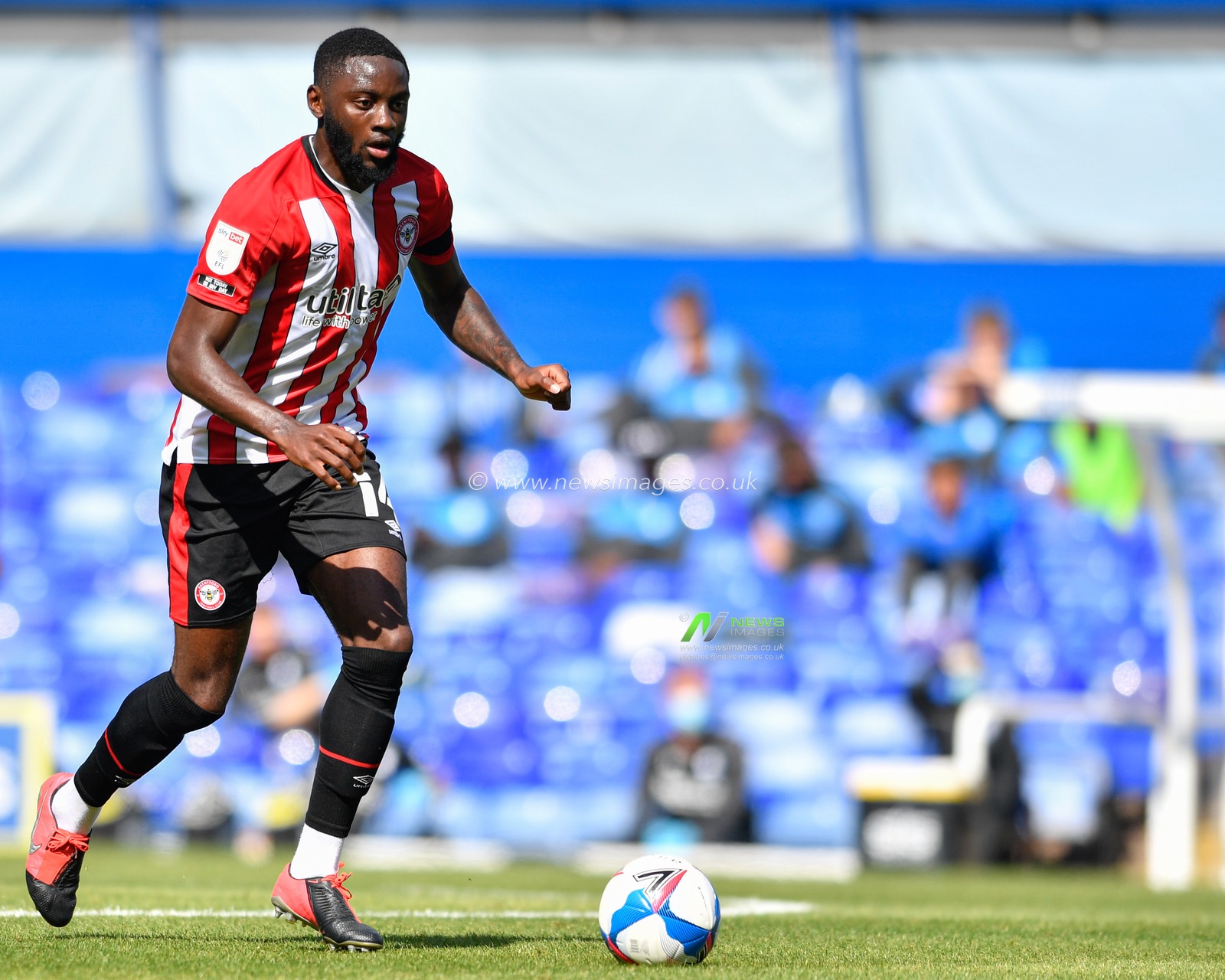 Josh Dasilva (14) of Brentford runs forward with the ball