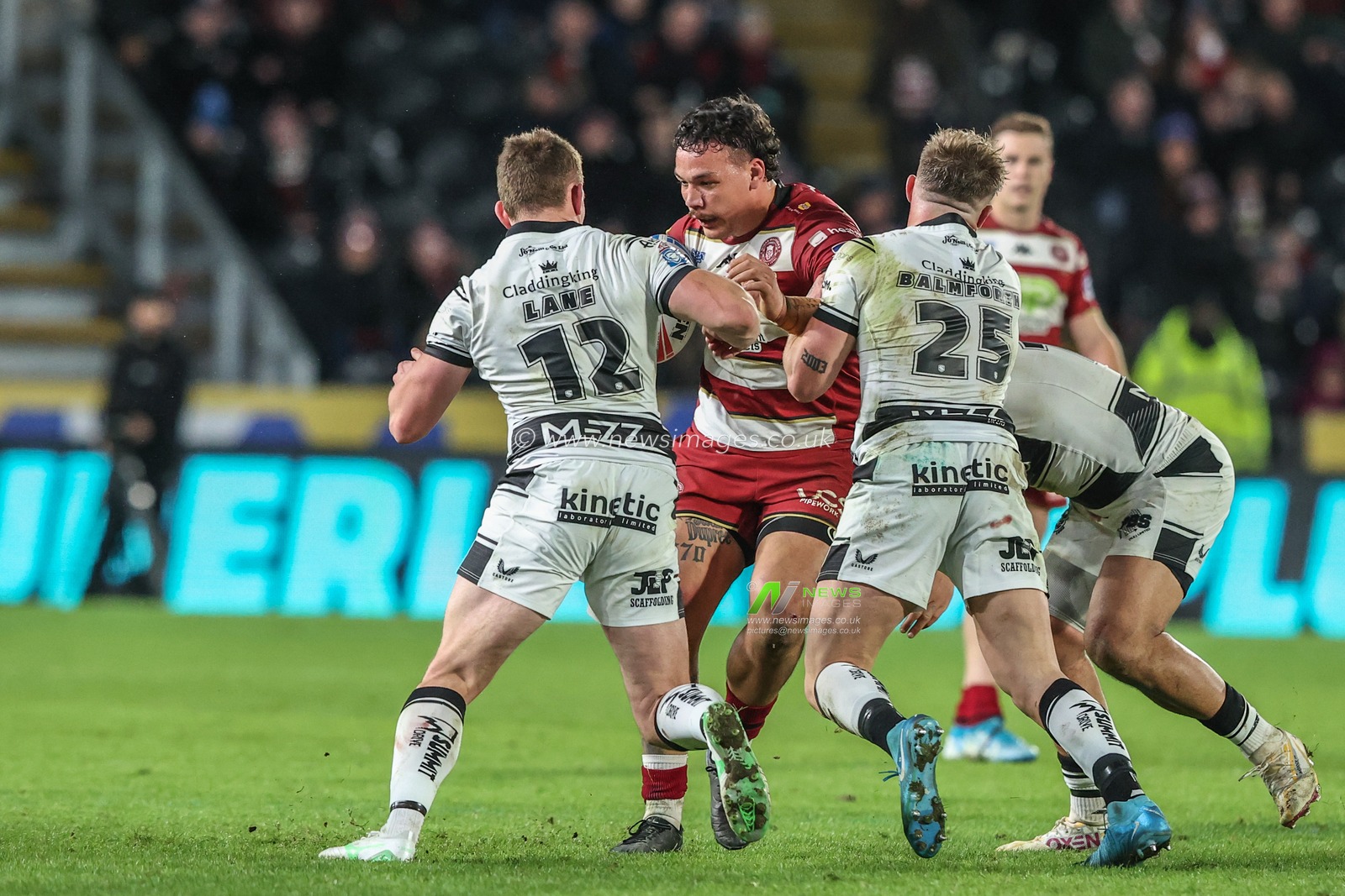 Tyler Dupree of Wigan Warriors is tackled by Jordan Lane of Hull FC and Denive Balmforth of Hull FC during the Betfred Super League Round 2 match Hull FC vs Wigan Warriors at MKM Stadium, Hull, United Kingdom, 21st February 2025

(Photo by Alfie Cosgrove/News Images)