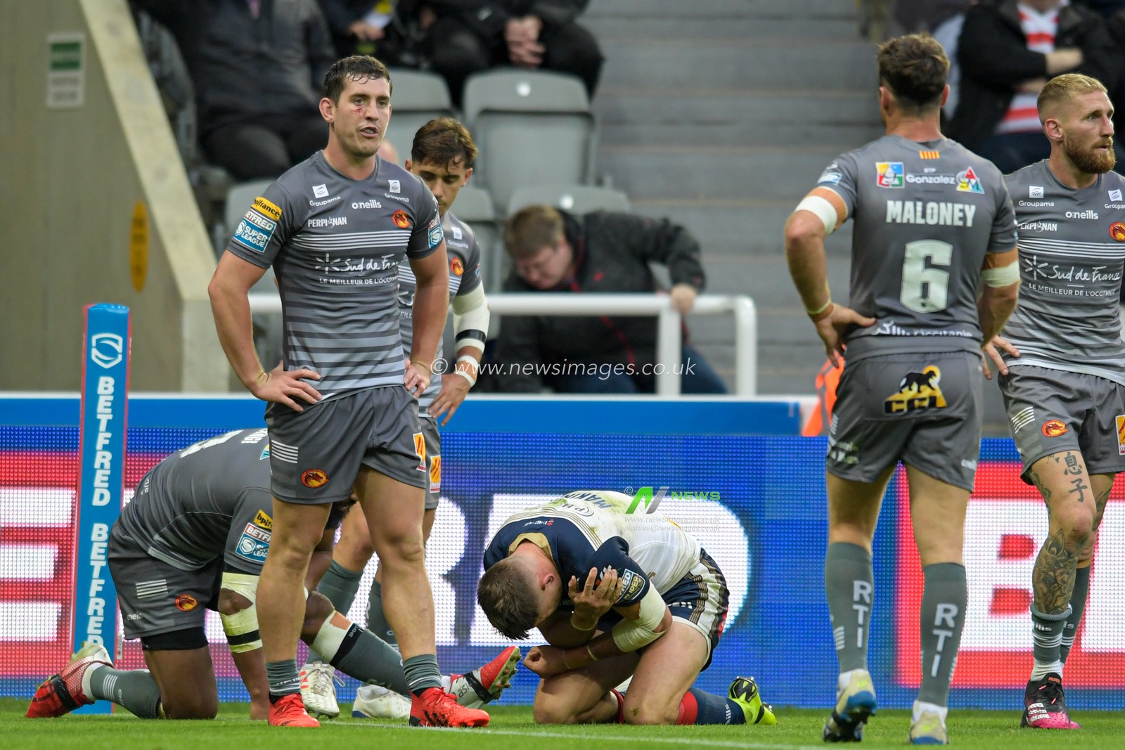 Tommy Makinson (2) of St Helens holds his shoulder in pain