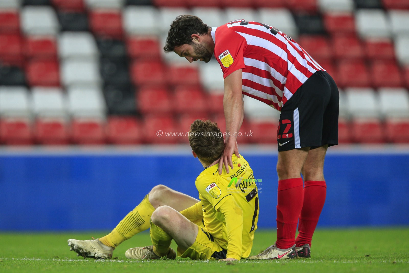 Will Grigg #22 of Sunderland checks on Stephen Quinn #7 of Burton Albion