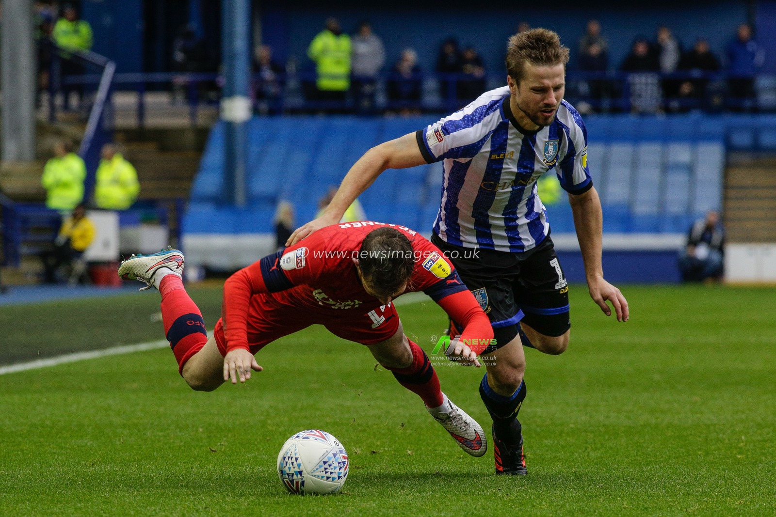 5th October 2019, Hillsborough, Sheffield, England; Sky Bet Championship, Sheffield Wednesday v Wigan Athletic : Julian Borner (13) of Sheffield Wednesday pulls Charlie Mulgrew over 

Credit: Kurt Fairhurst/News Images