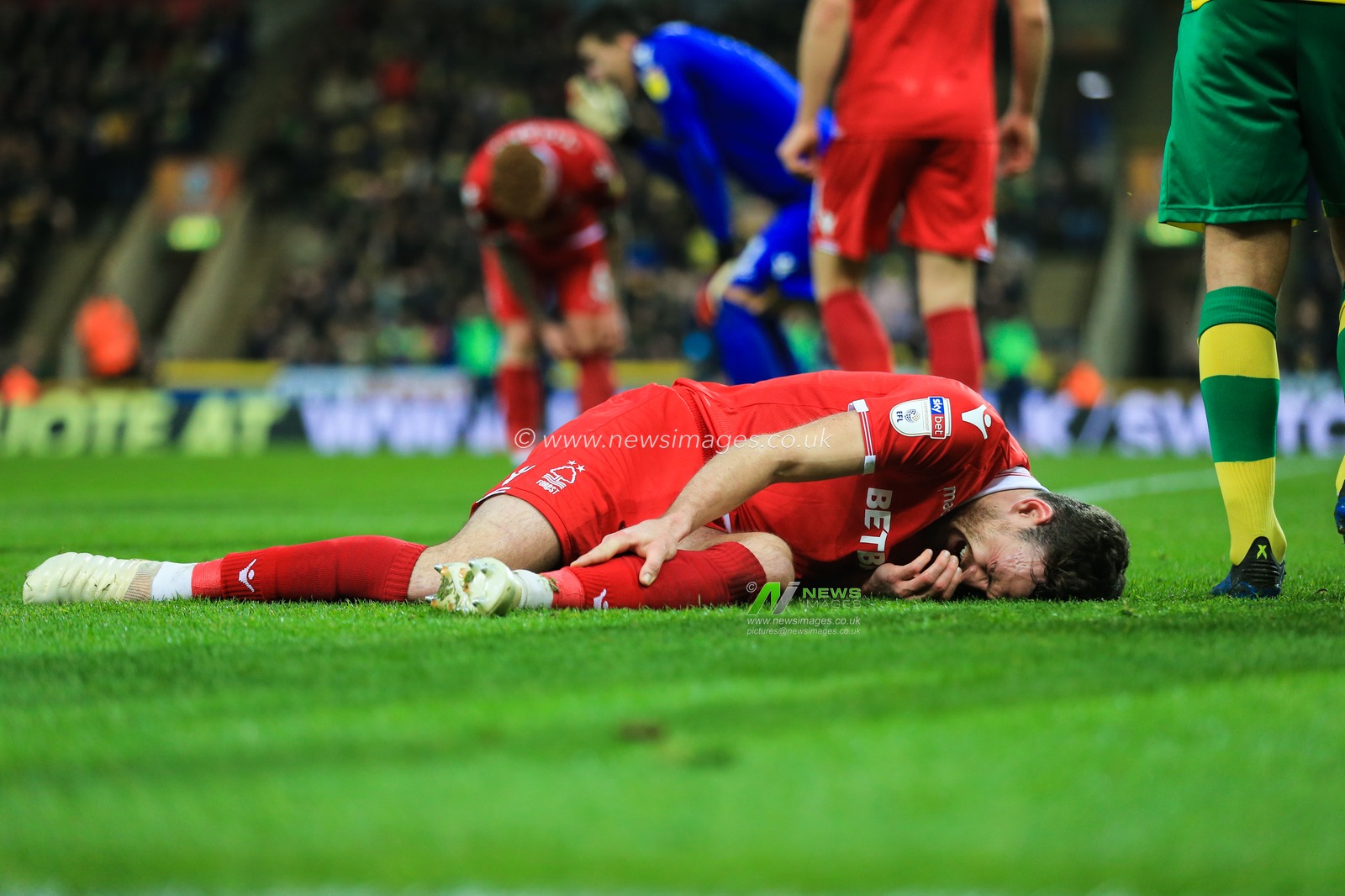 26th December 2018, Carrow Road, Norfolk, England; Sky Bet Championship, Norwich City vs Nottingham Forest ;  Jack Robinson (18) of Nottingham Forest lies clutching his leg after being fouled by Marco Stiepermann (18) of Norwich City

Credit: Georgie Kerr/News Images

English Football League images are subject to DataCo Licence