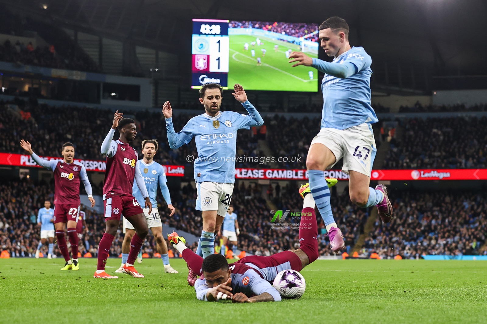 Ezri Konsa of Aston Villa is fouled by Bernardo Silva of Manchester City during the Premier League match Manchester City vs Aston Villa at Etihad Stadium, Manchester, United Kingdom, 3rd April 2024

(Photo by Mark Cosgrove/News Images)