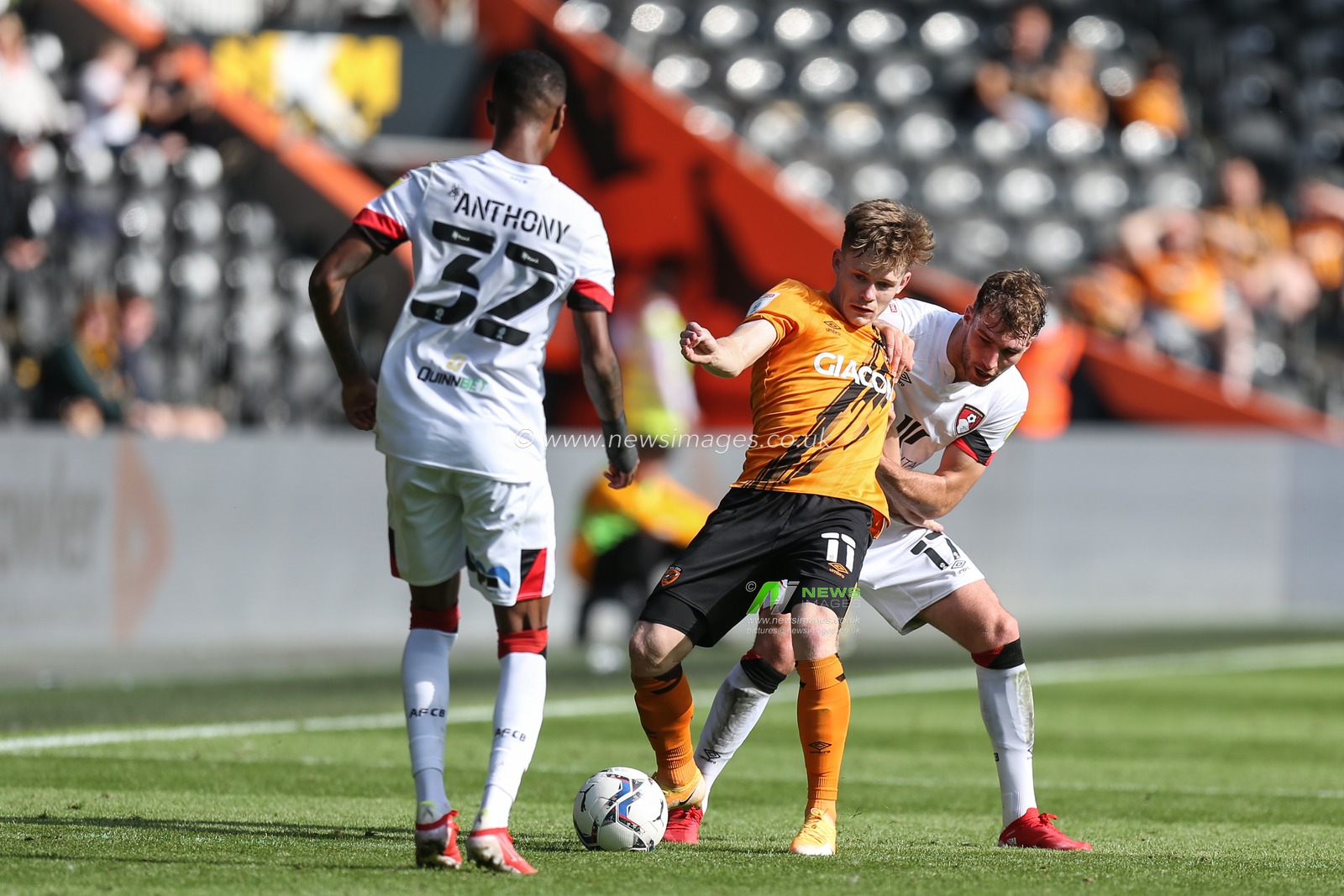 Keane Lewis-Potter #11 of Hull City defends the ball from Jack Stacey #17 of Bournemouth