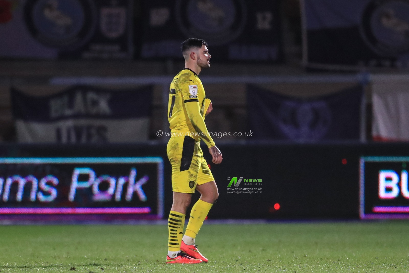 Alex Mowatt #27 of Barnsley walks back to the dressing room after being sent off