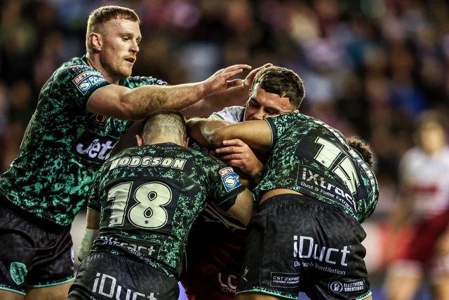 Kaide Ellis of Wigan Warriors is tackled by Bailey Hodgson of Leigh Leopards and Jacob Alick-Wiencke of Leigh Leopards during the Betfred Super League match Wigan Warriors vs Leigh Leopards at The Brick Community Stadium, Wigan, United Kingdom on 26 February 2026

(Photo by Alfie Cosgrove/News Images)