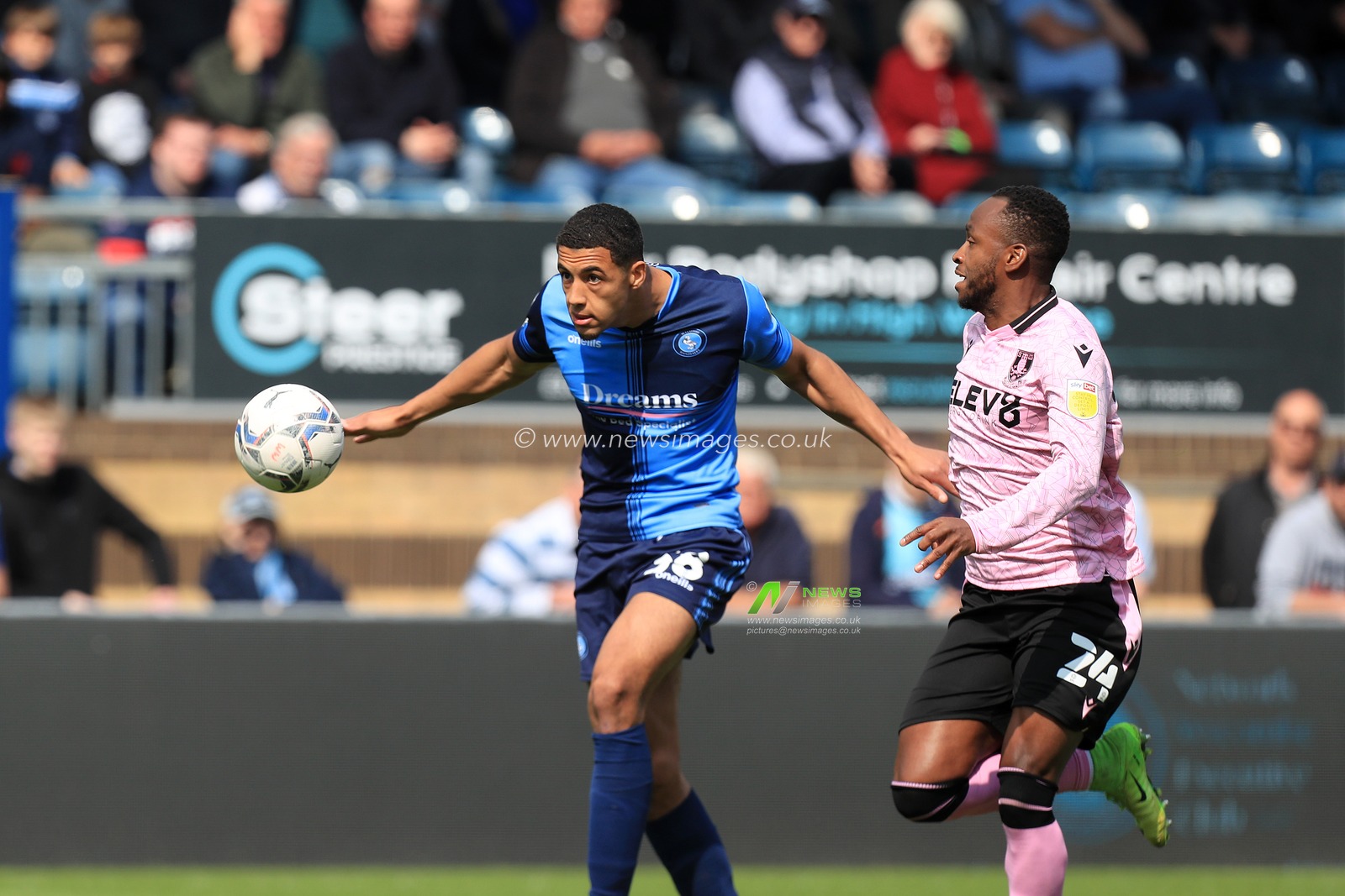 Chris Forino-Joseph #38 of Wycombe Wanderers heads back under pressure from Saido Berahino #24 of Sheffield Wednesday