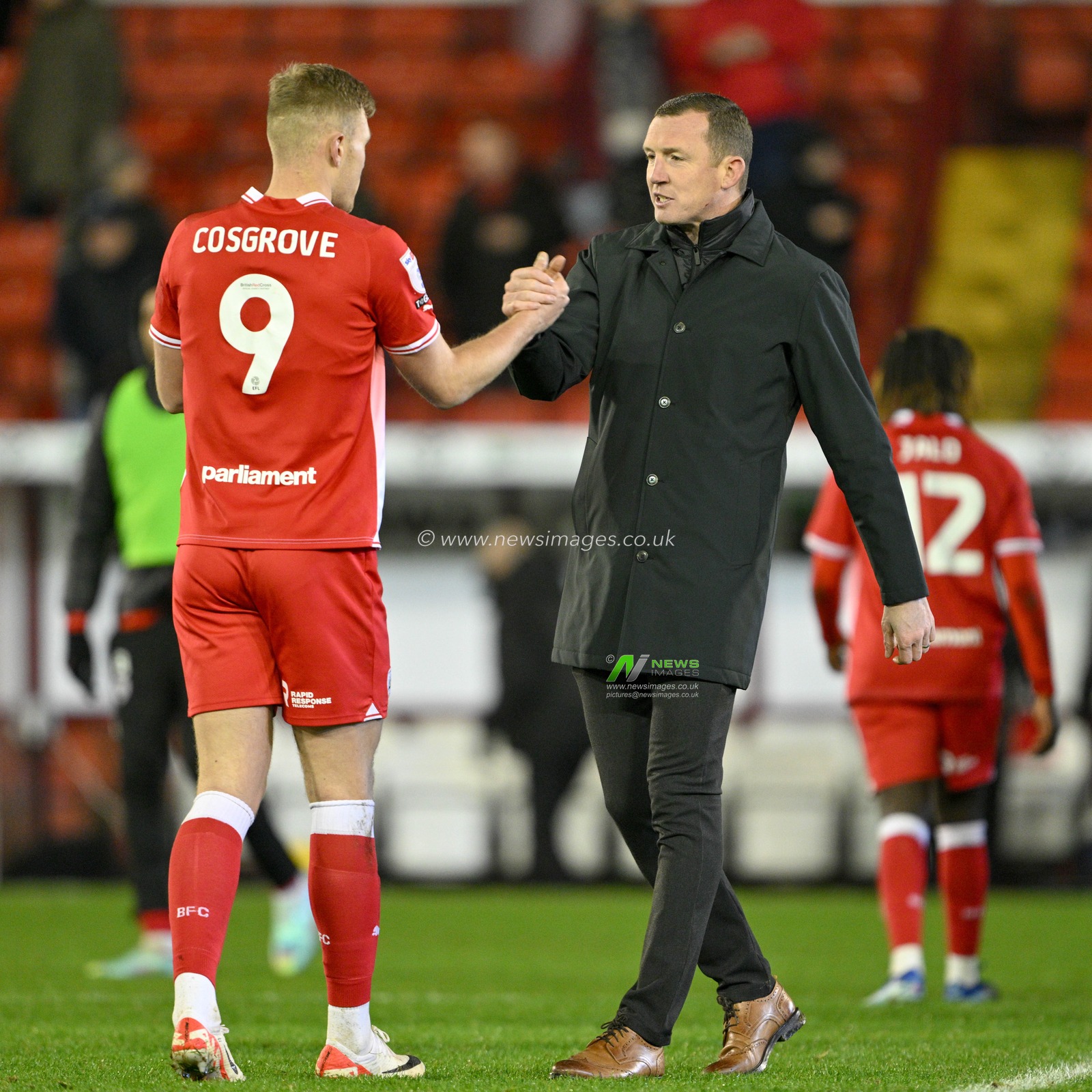 Neill Collins Head coach of Barnsley congratulates Sam Cosgrove #9 of Barnsley at full time, during the Sky Bet League 1 match Barnsley vs Wycombe Wanderers at Oakwell, Barnsley, United Kingdom, 28th November 2023

(Photo by Cody Froggatt/News Images)